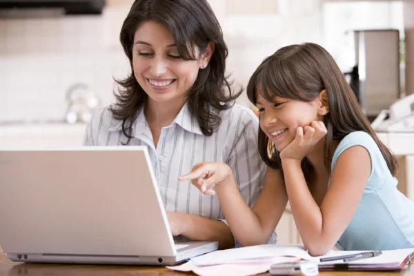 photo credit: GSCSNJ <a href="http://www.flickr.com/photos/44102337@N03/7882614208">Woman and young girl in kitchen with laptop and paperwork smiling</a> via <a href="http://photopin.com">photopin</a> <a href="https://creativecommons.org/licenses/by-nc/2.0/">(license)</a>