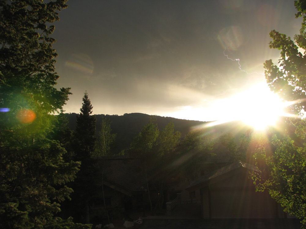The view from our lodge as storm clouds roll over the mountains in the distance...if you look closely you can see a lightning streak right above the sun