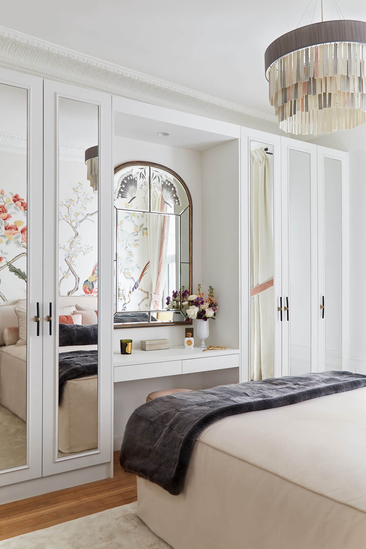  In this bedroom, the soft and alluring ambiance comes from items such as the fine Italian 1940s Art Deco mirror engraved with two exquisite butterflies with a gilded frame, the modern porcelain chandelier, and the rich mix of materials and textures.