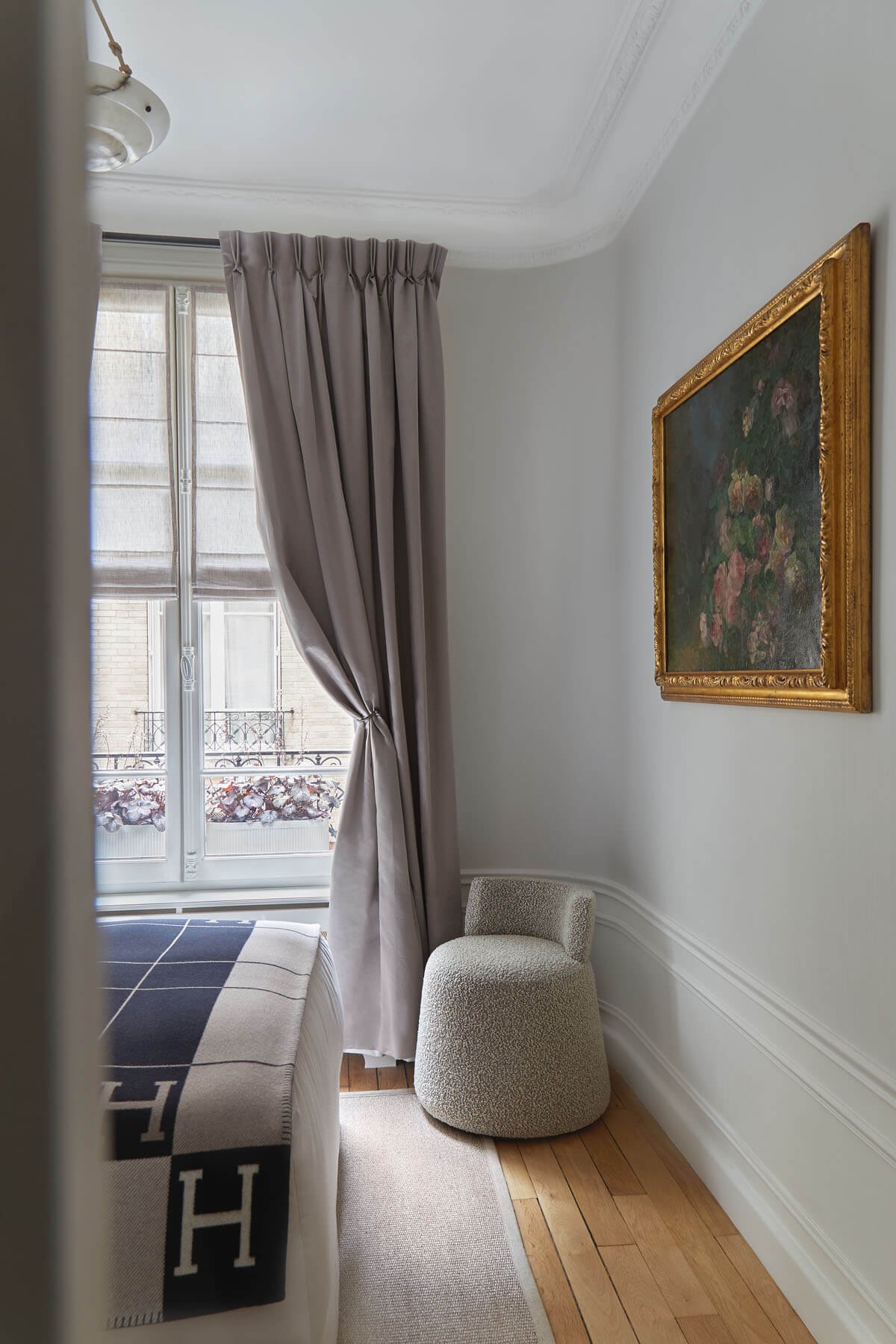  Texture contrast brings sensory interest. The armchair selected in this guest bedroom is the perfect fit to embrace the discreet curved wall. This little beauty is upholstered with a textured fabric by Bisson Bruneel. The material adds textural cont