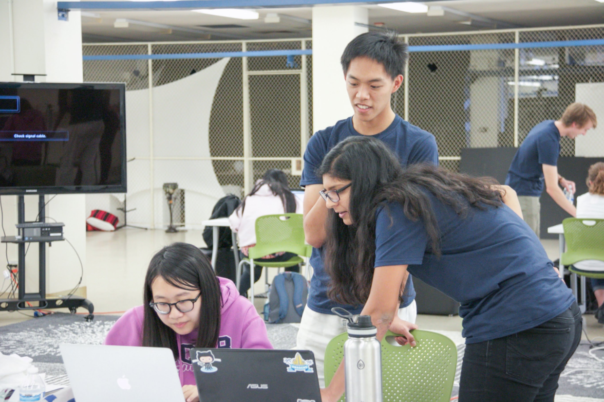 Participants of a Django Girls workshop code with the support of mentors from the Data Science club in the DAHC.