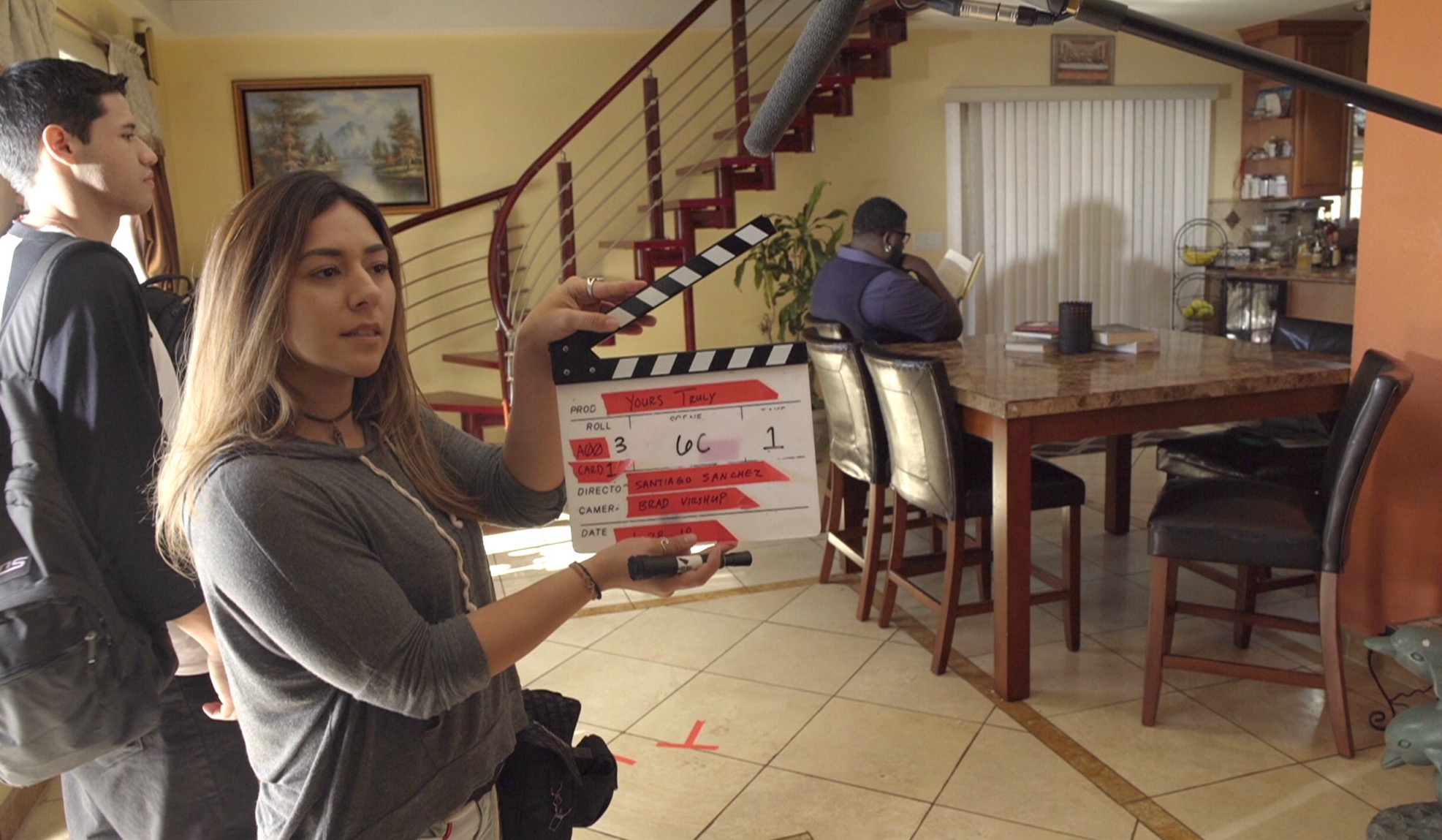 Aryana Moreno prepping the clapperboard for her next film project, Yours Truly.