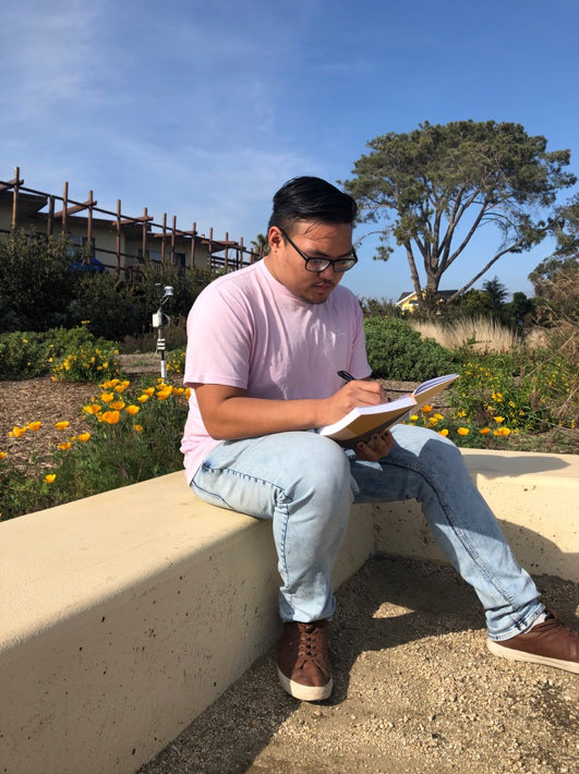 Tomas Palpallatoc, a first-year UCSB sociology major, writing fresh poetry in preparation for his final Poetry Slam.