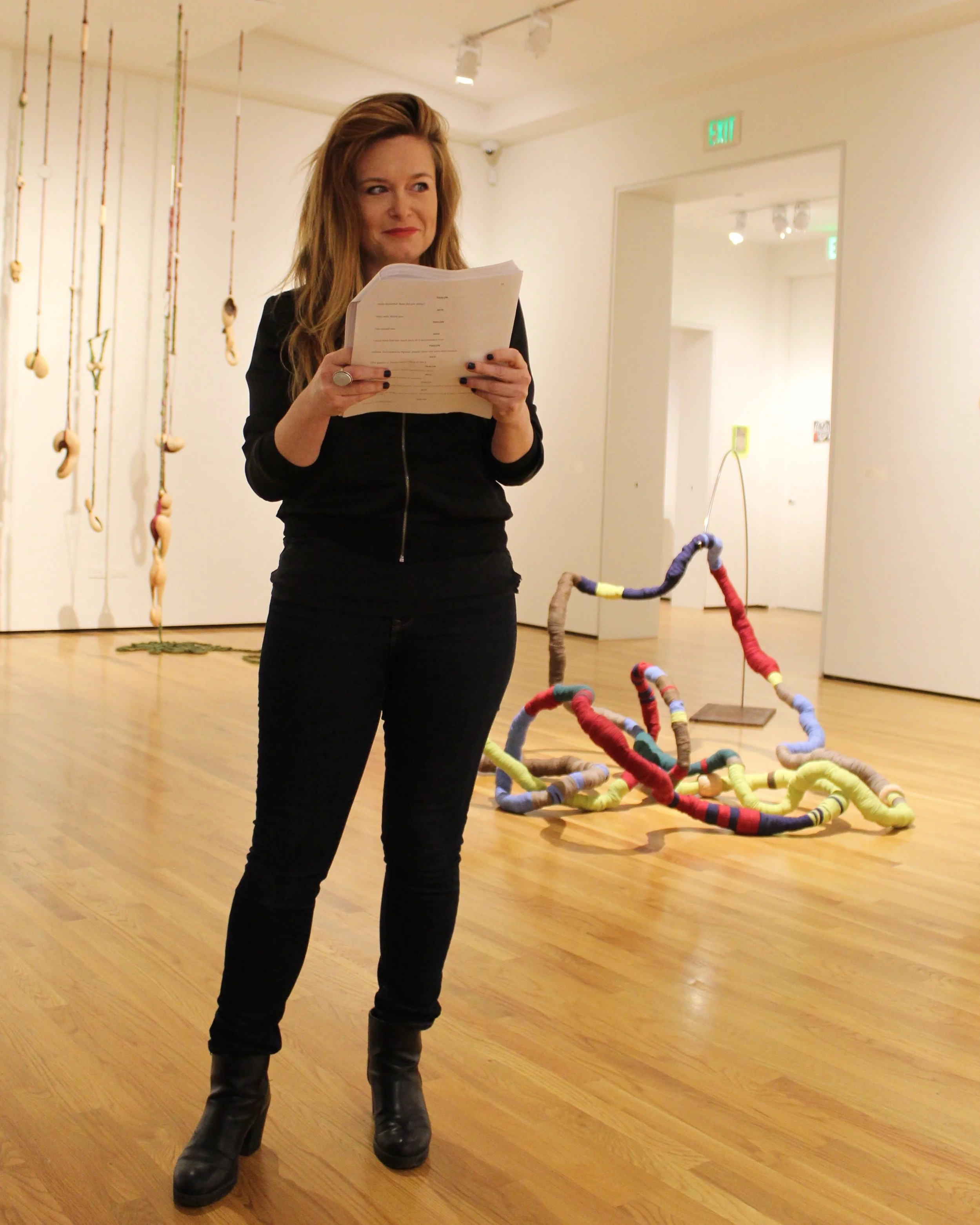 Maiza Hixson announces scenes and stage directions throughout the play reading.
