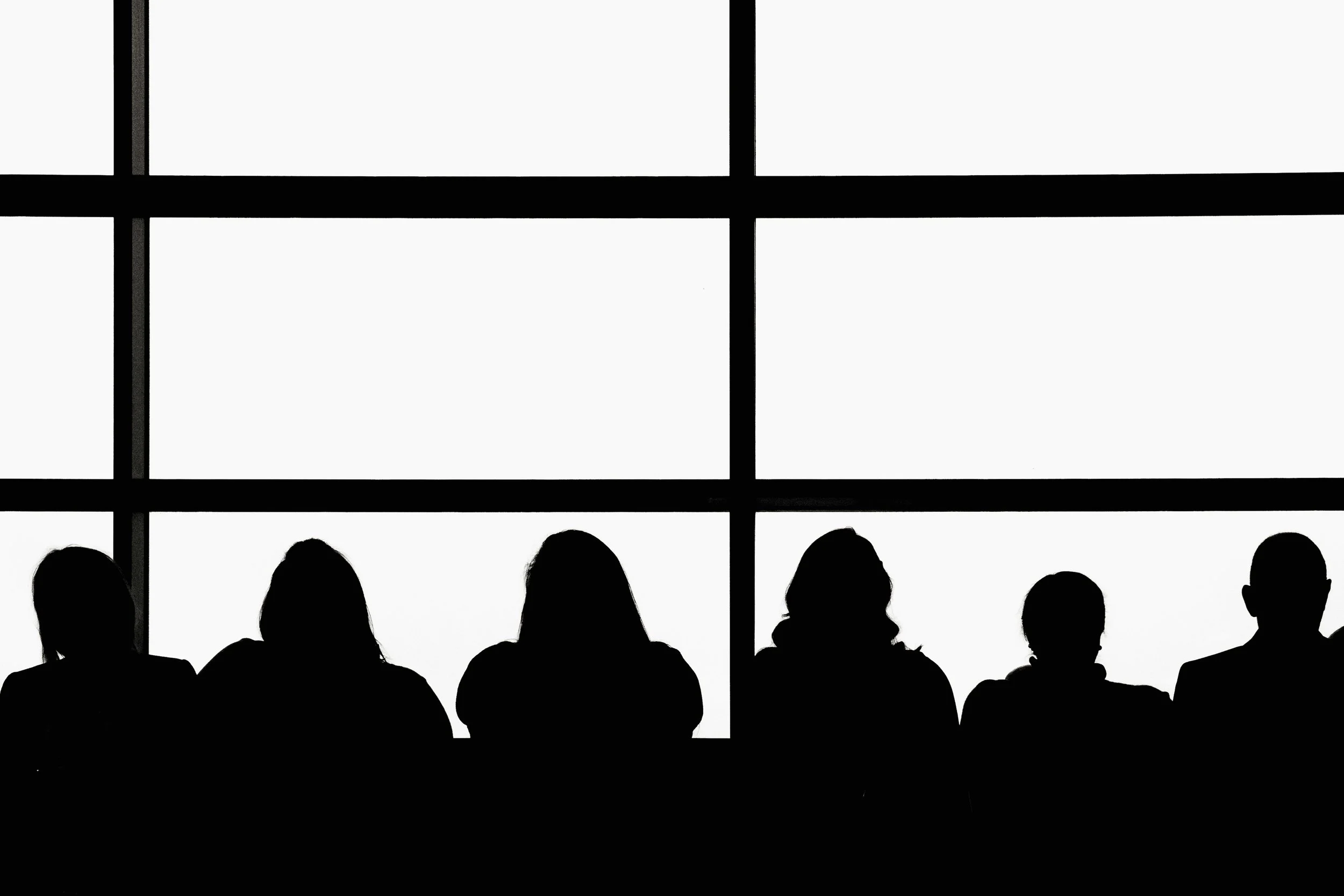 Members of an audience sitting in a row