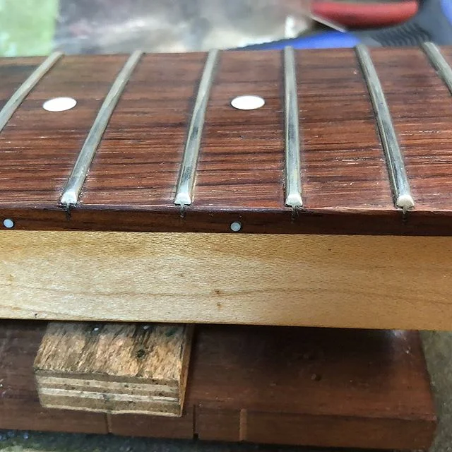 Fixing loose frets, topping it off with a full fret dress on this NYC Empire 5 by #fodera . #foderabass #foderaguitars #luthiersg #singapore #luthier #masterluthier #waynelim #guitarplayers #guitarplayer #guitarists #guitarist #guitars #guitar #awesomeguitars #guitarporn #musicians #musician #guitaroftheday #photography #photos #photo #famousguitars #guitarplayers #guitarplayer #singapore #guitarrepair #photos #luthiers #luthiery #guitarrepairs