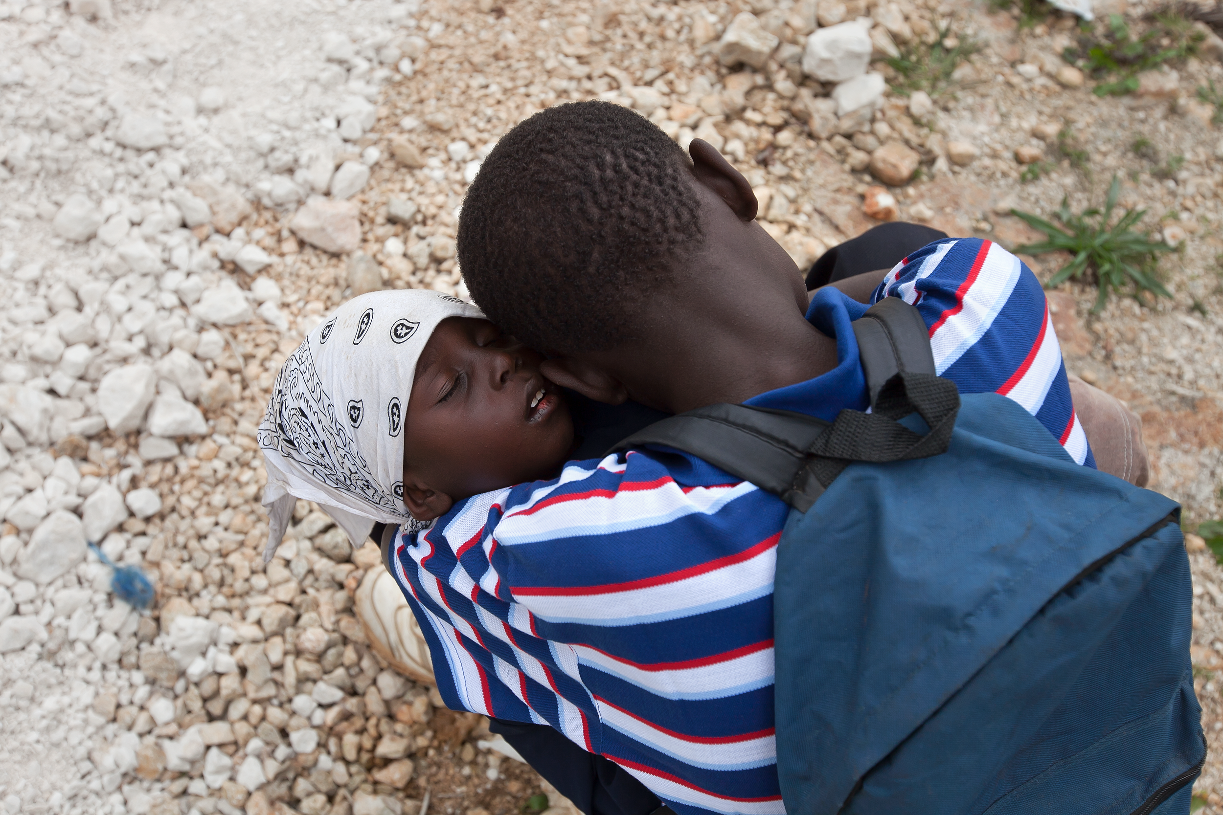 A Haitian man holds his sick child while waiting for care at the MTM clinic in Gramothe,Haiti. 