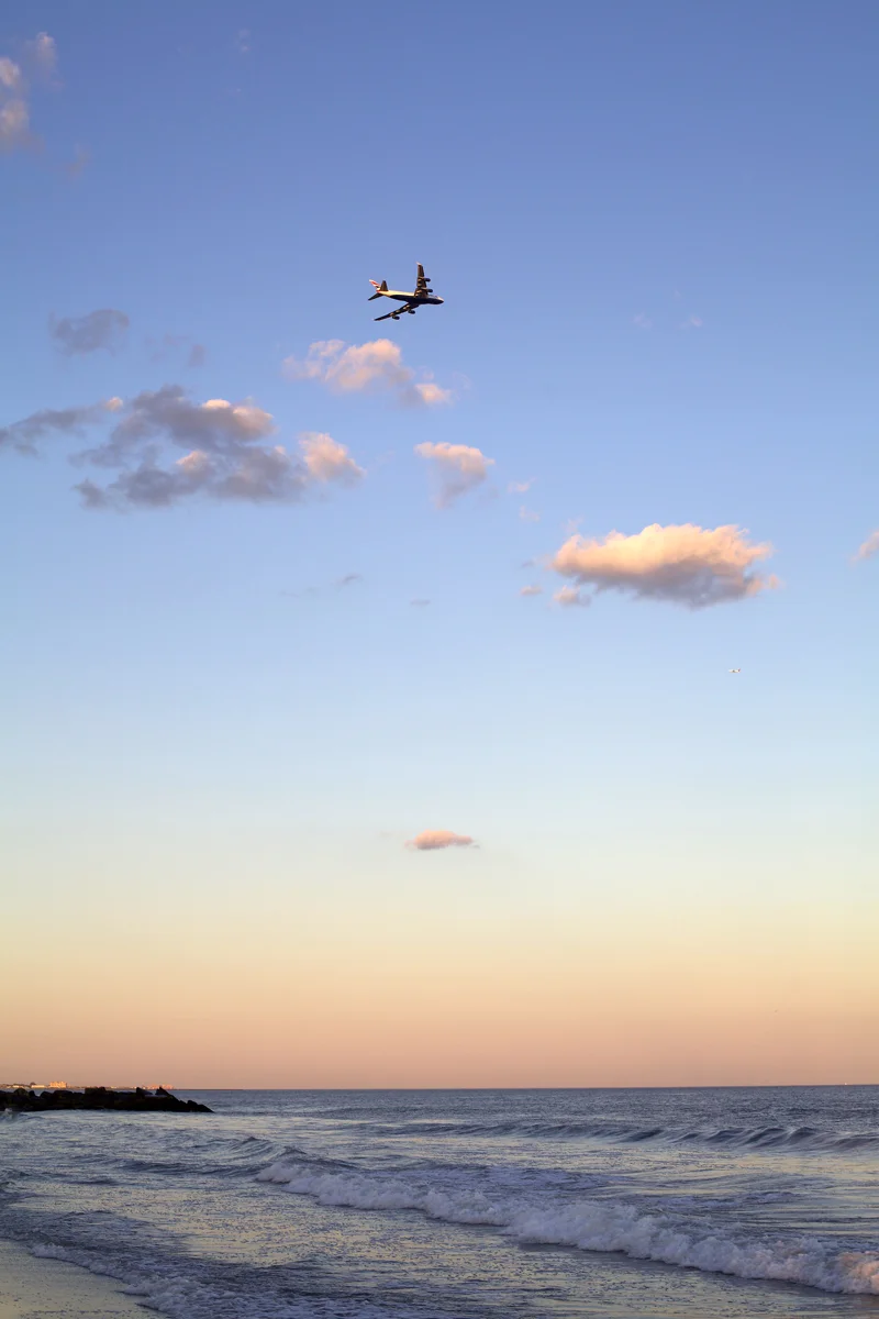 plane-flying-at-sunset-over-beach.jpg