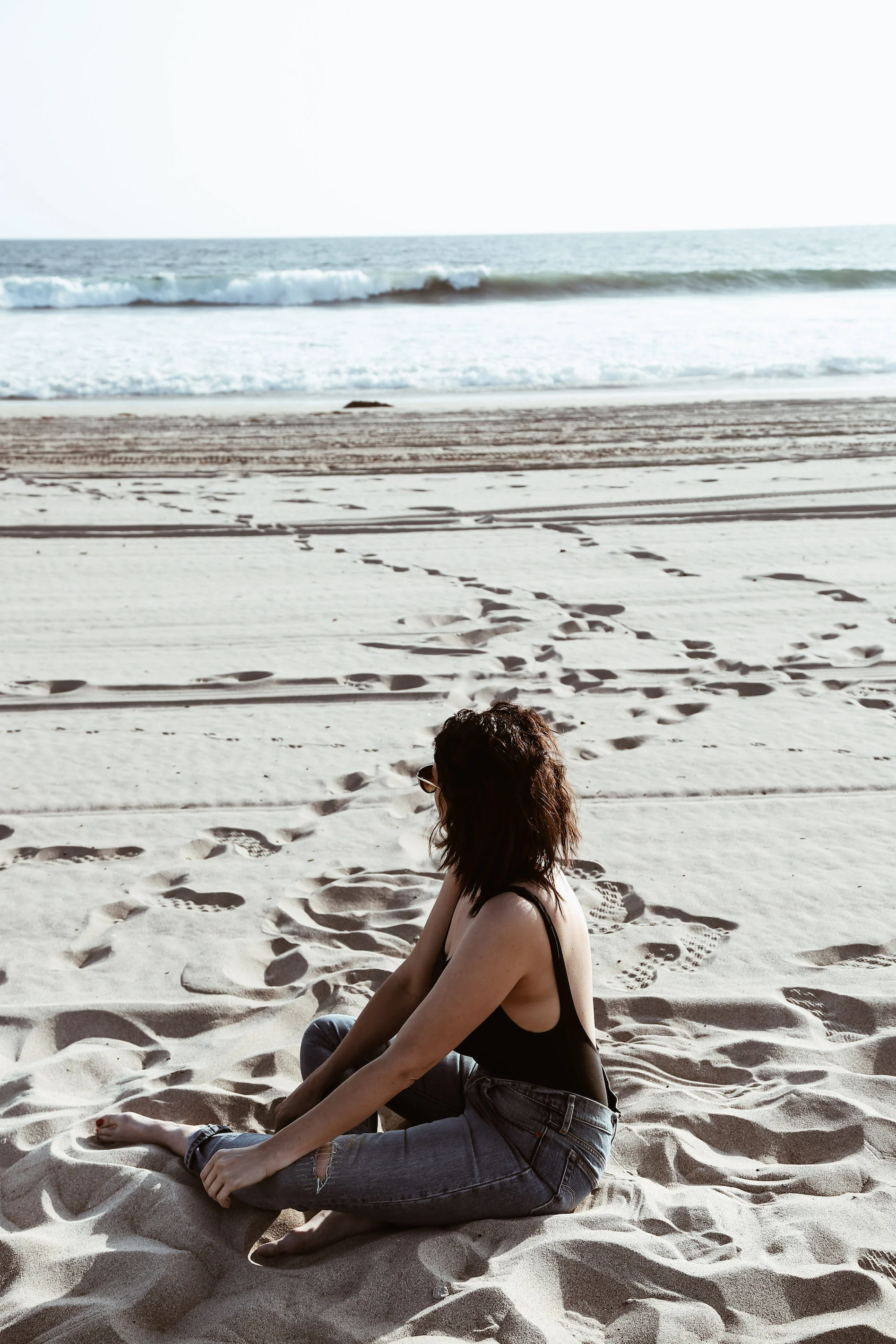 black one-piece swimsuit and levis on the beach3.jpg