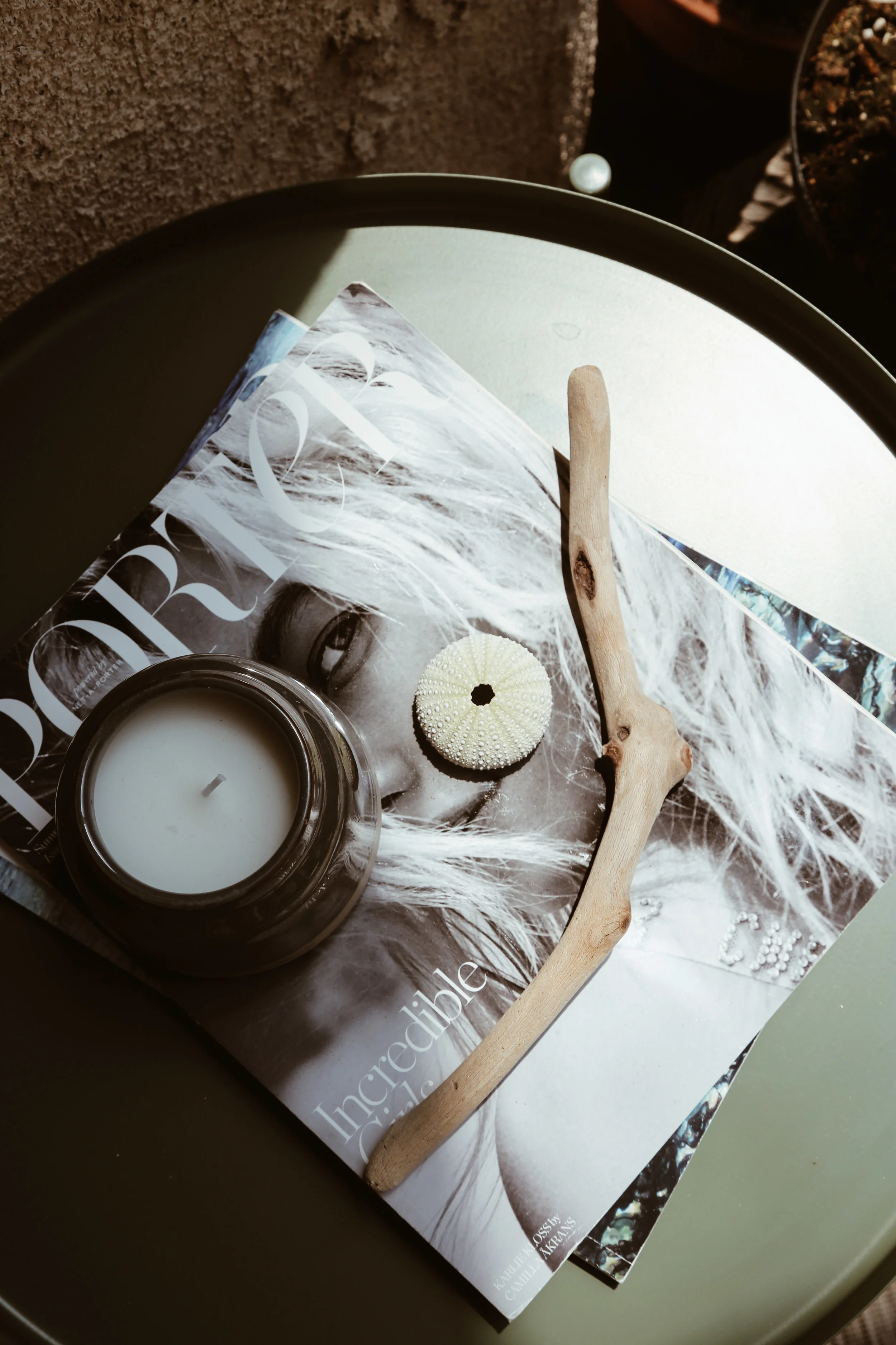 simple table top style with porter magazine and shells.jpg
