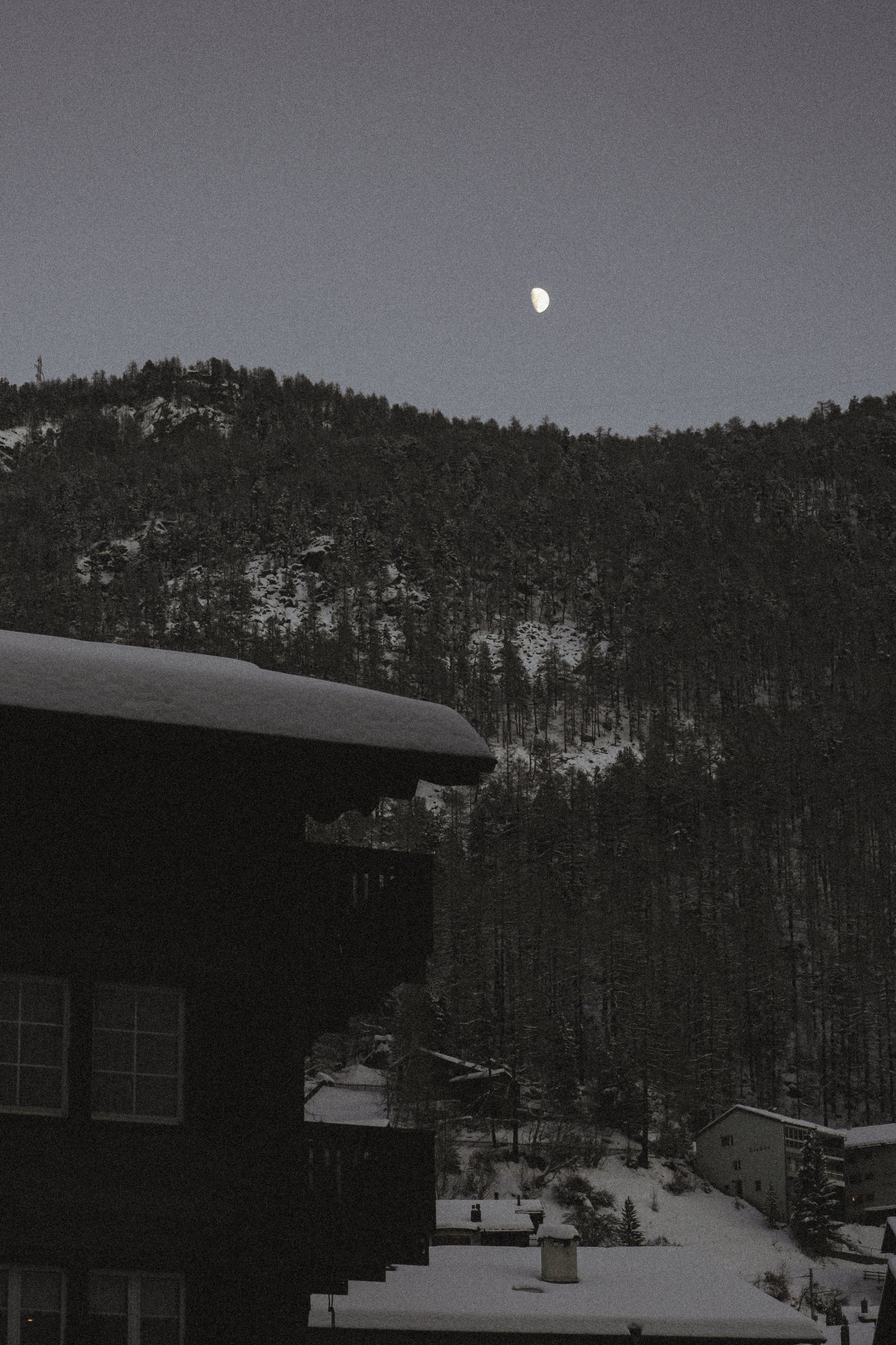 snow covered cabins at dusk in Zermatt