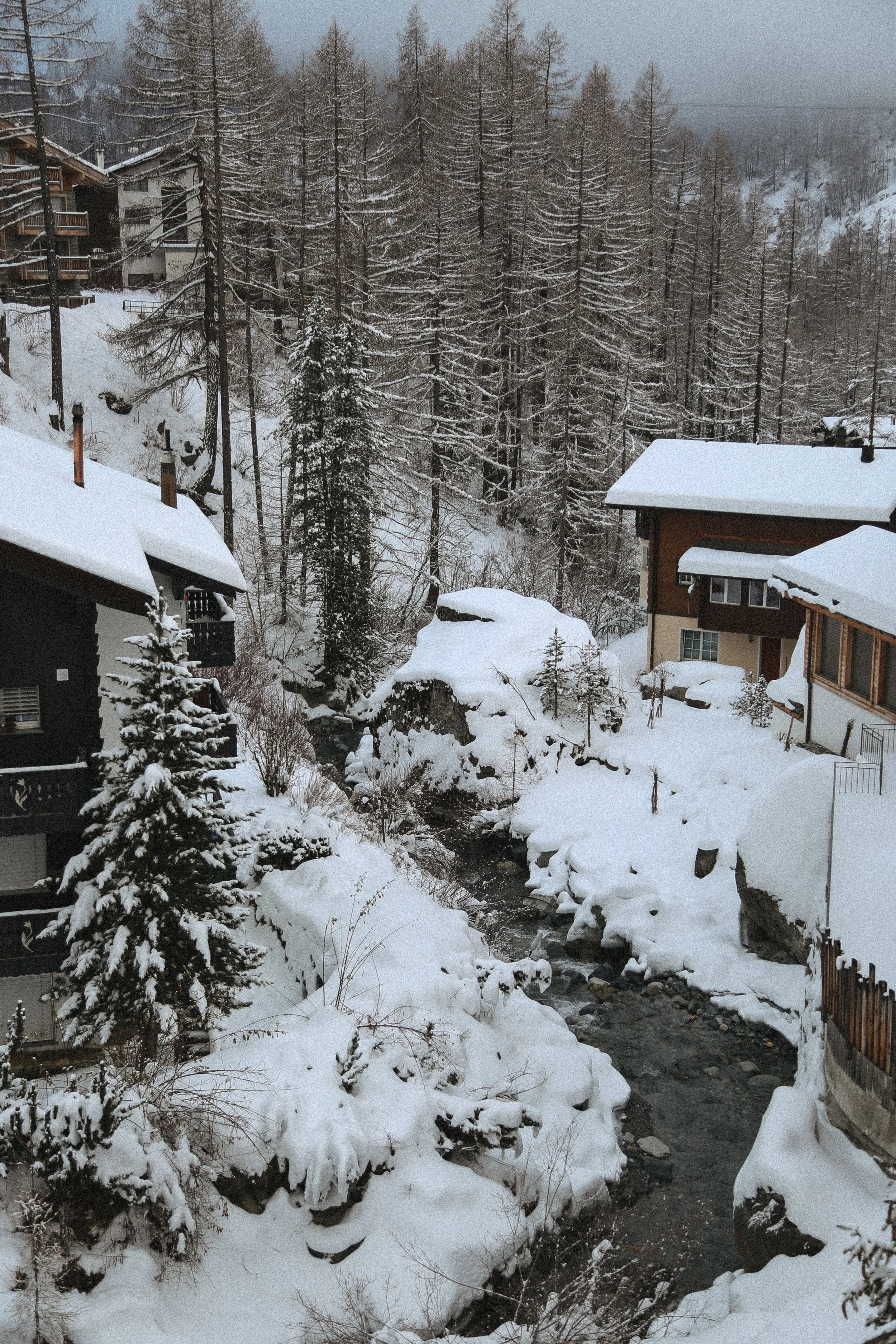 snow covered cabins in the woods in Zermatt