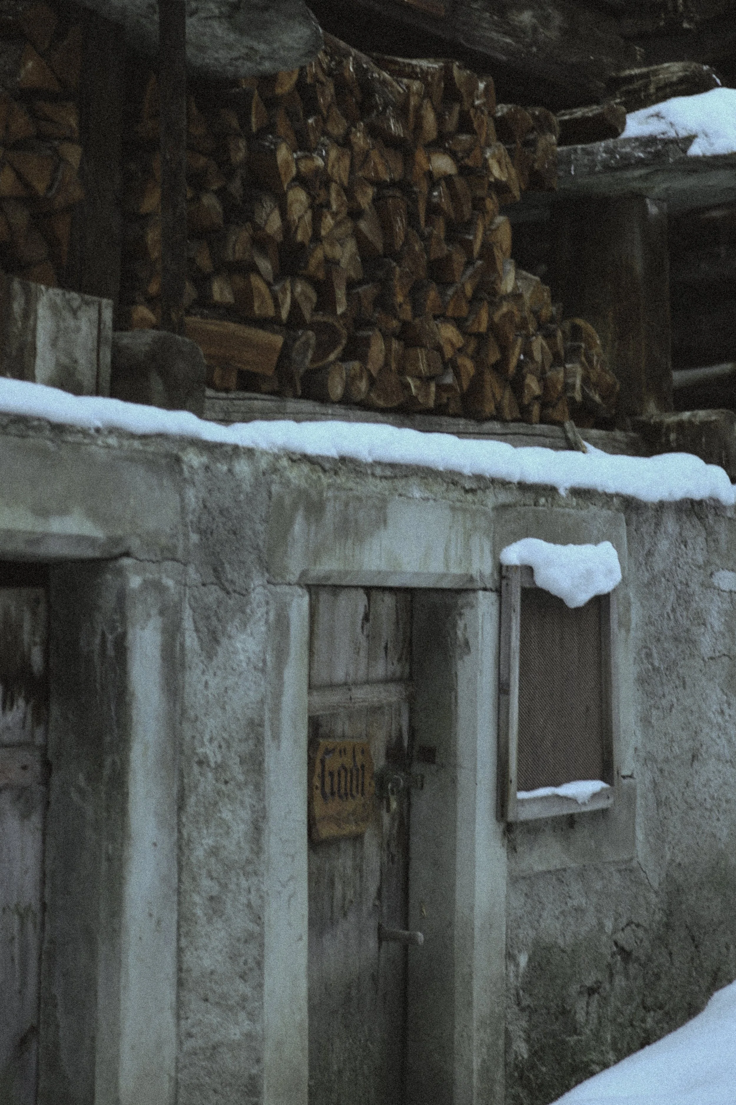 pile of wood logs in the snow in Switzerland