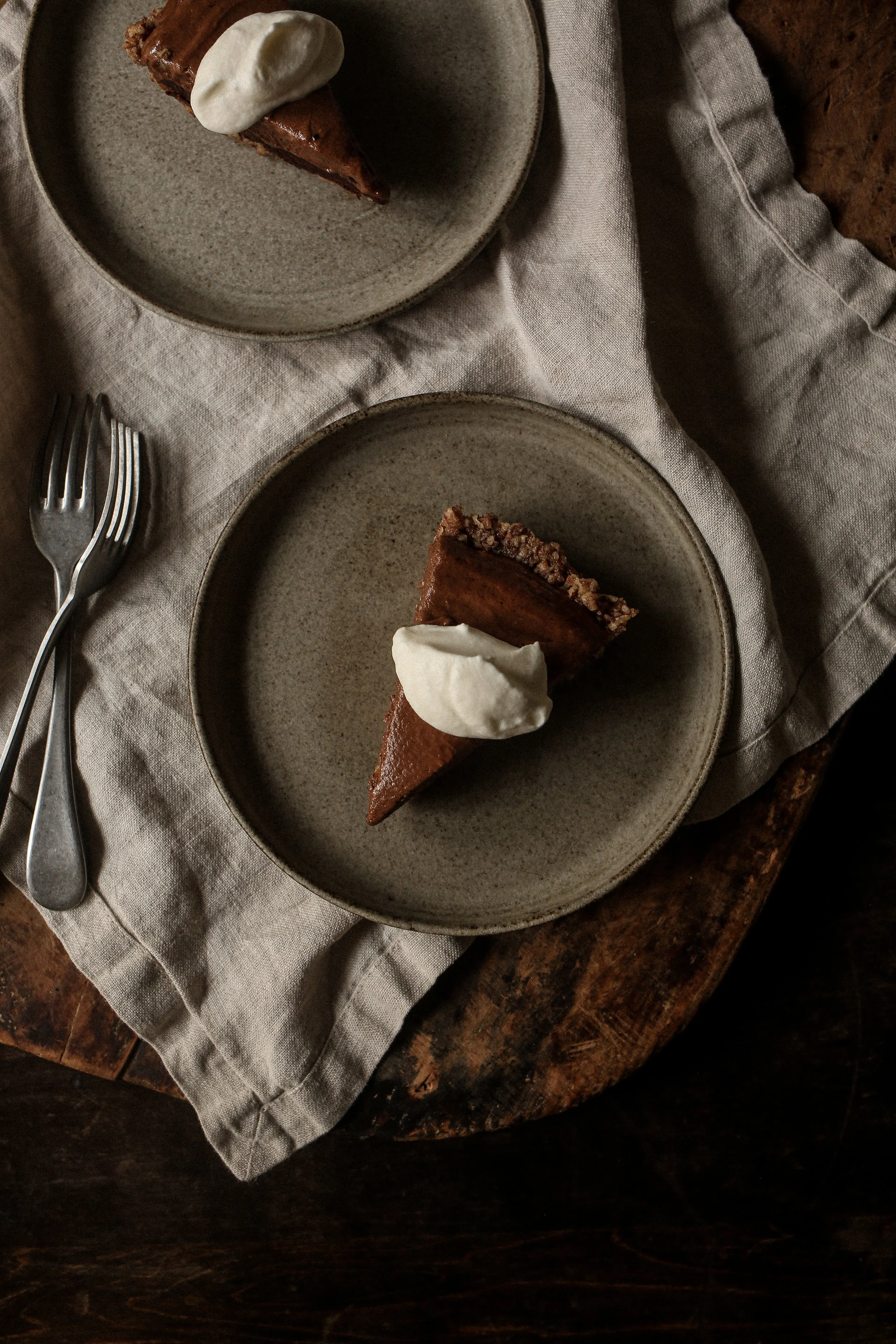 Chocolate pecan torte topped with whipped cream