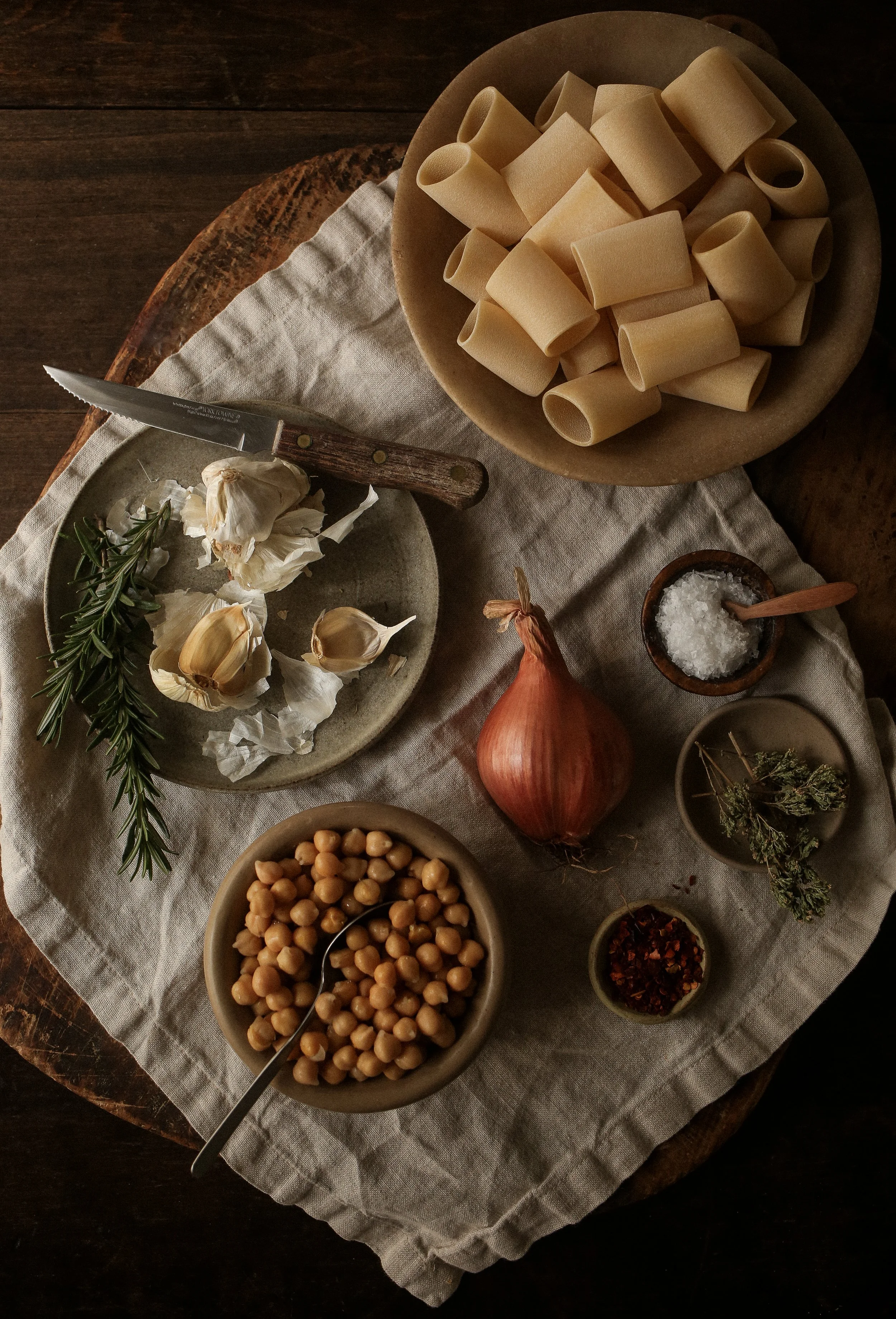 Ingredients for pasta e ceci including chickpeas, olive oil, garlic, shallot, rosemary, and pasta