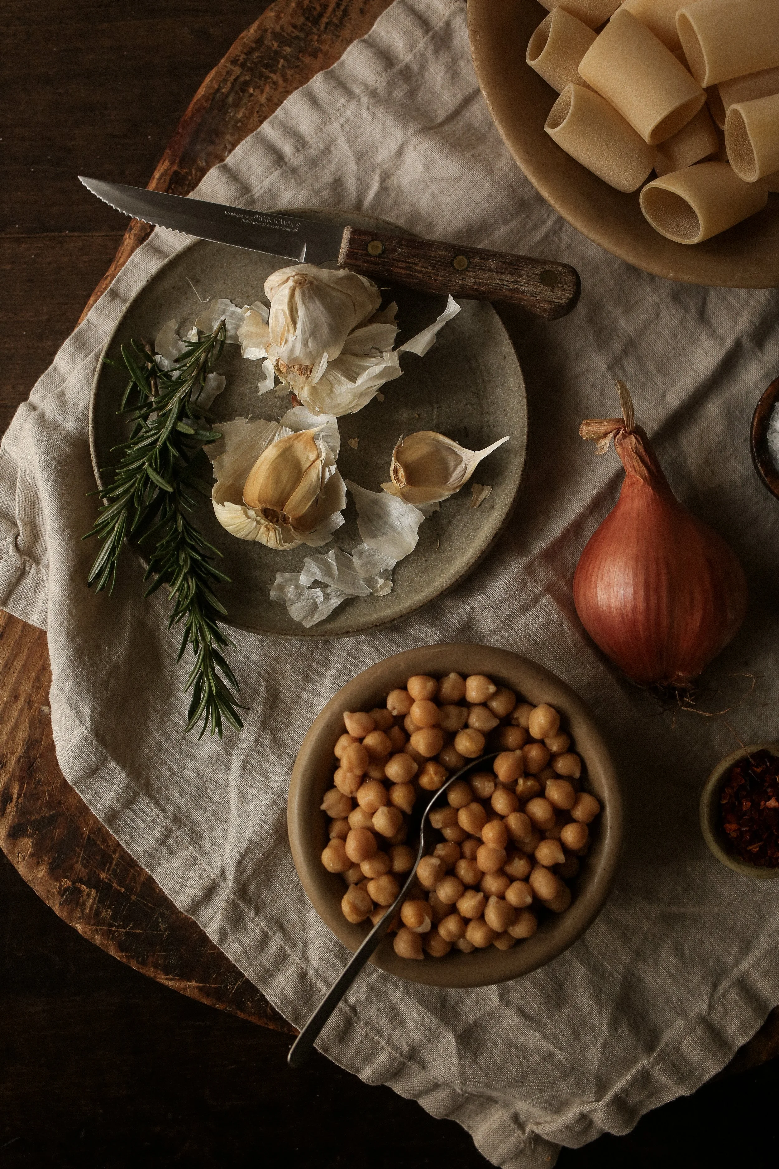 garlic and rosemary on a plate on a wooden table