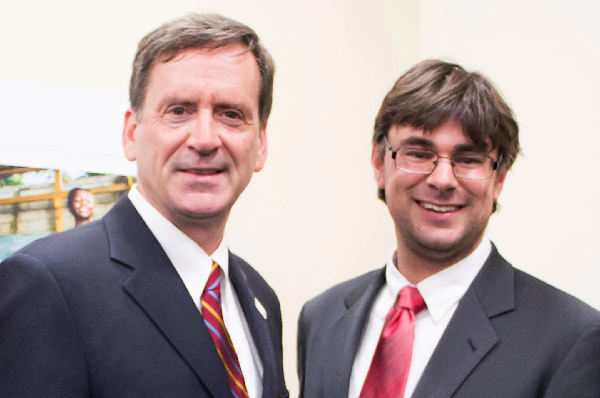 Simon Moss (right) welcoming Ambassador Green, USAID Administrator, to the celebration.