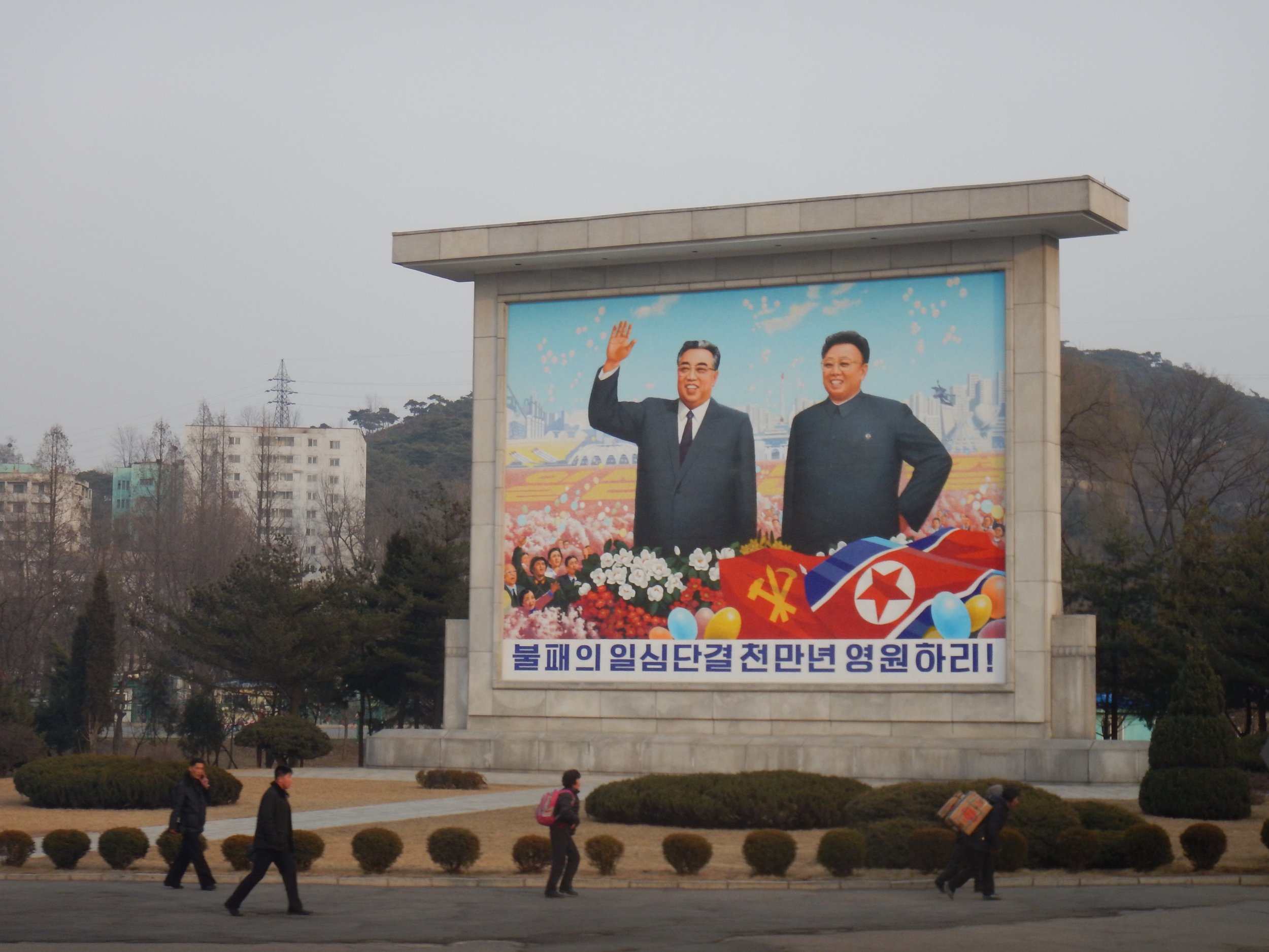  Hand-painted propaganda murals like this one in Pyongyang, featuring Kim Il-sung and Kim Jong-il smiling in a field of flowers, are commonplace in many larger North Korean cities. (Photo by Ethan Jakob Craft.) 