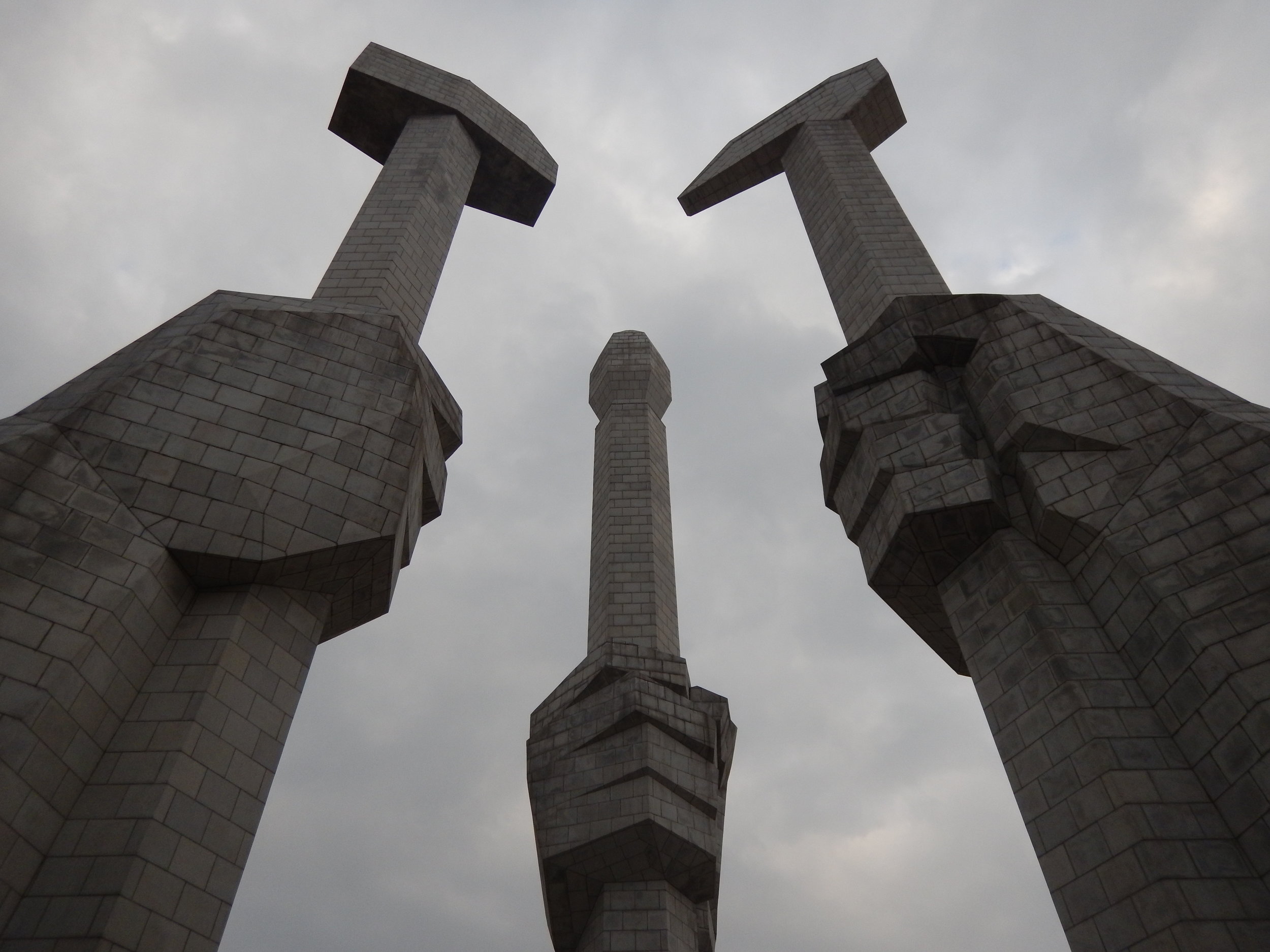  The Monument to the Foundation of the Party features three hands holding a hammer, representing the worker, a sickle, representing the farmer, and a paintbrush, representing the intellectual – these three tools are the official symbols of the ruling Worker's Party of Korea. (Photo by Ethan Jakob Craft.) 