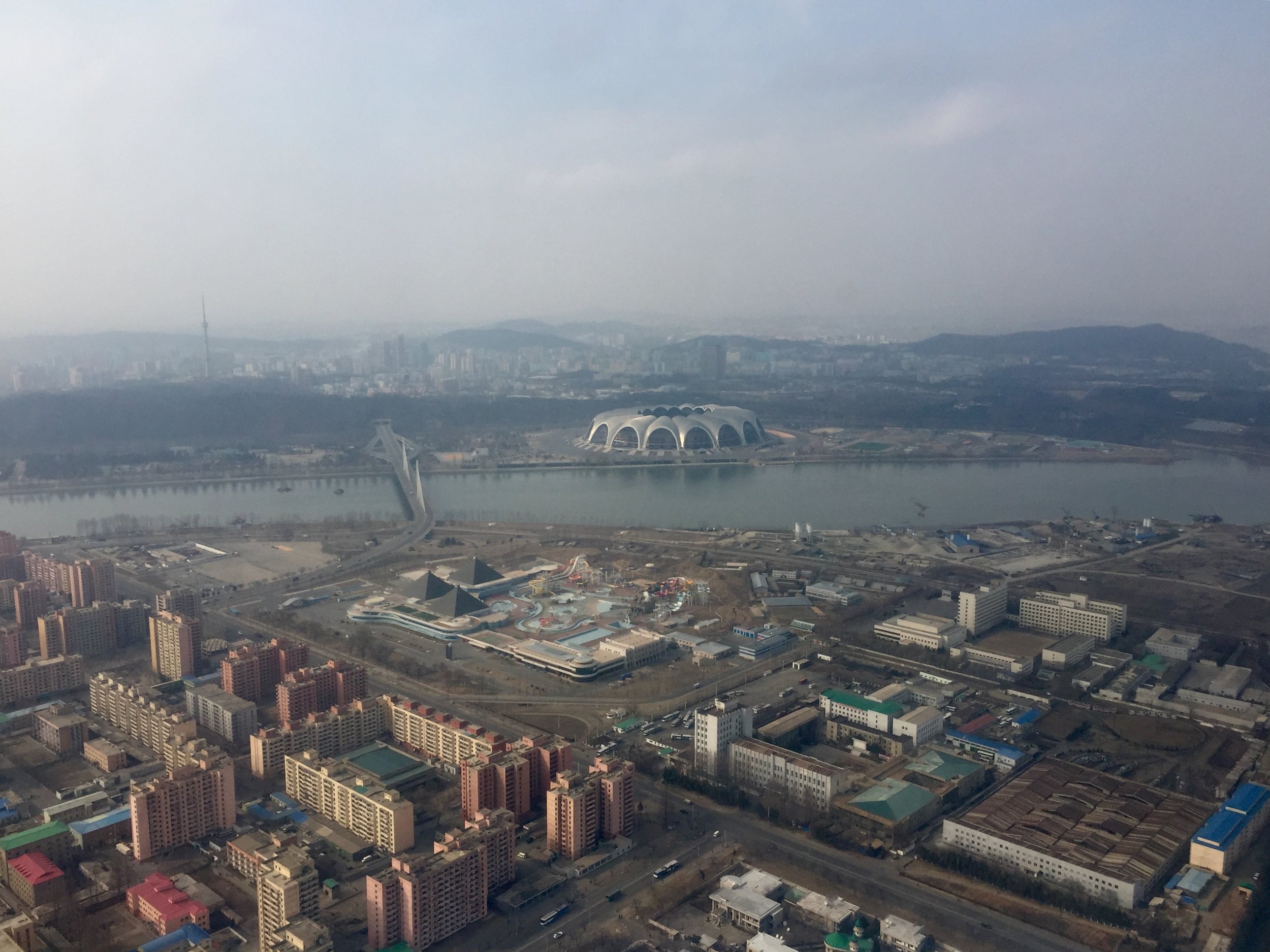  A view of northern Pyongyang as taken from an Air Koryo helicopter. The state-owned Munsu Waterpark can be seen in the foreground, and across the river is Mayday Stadium, the world's largest by capacity with 150,000 seats. (Photo by Ethan Jakob Craft.) 