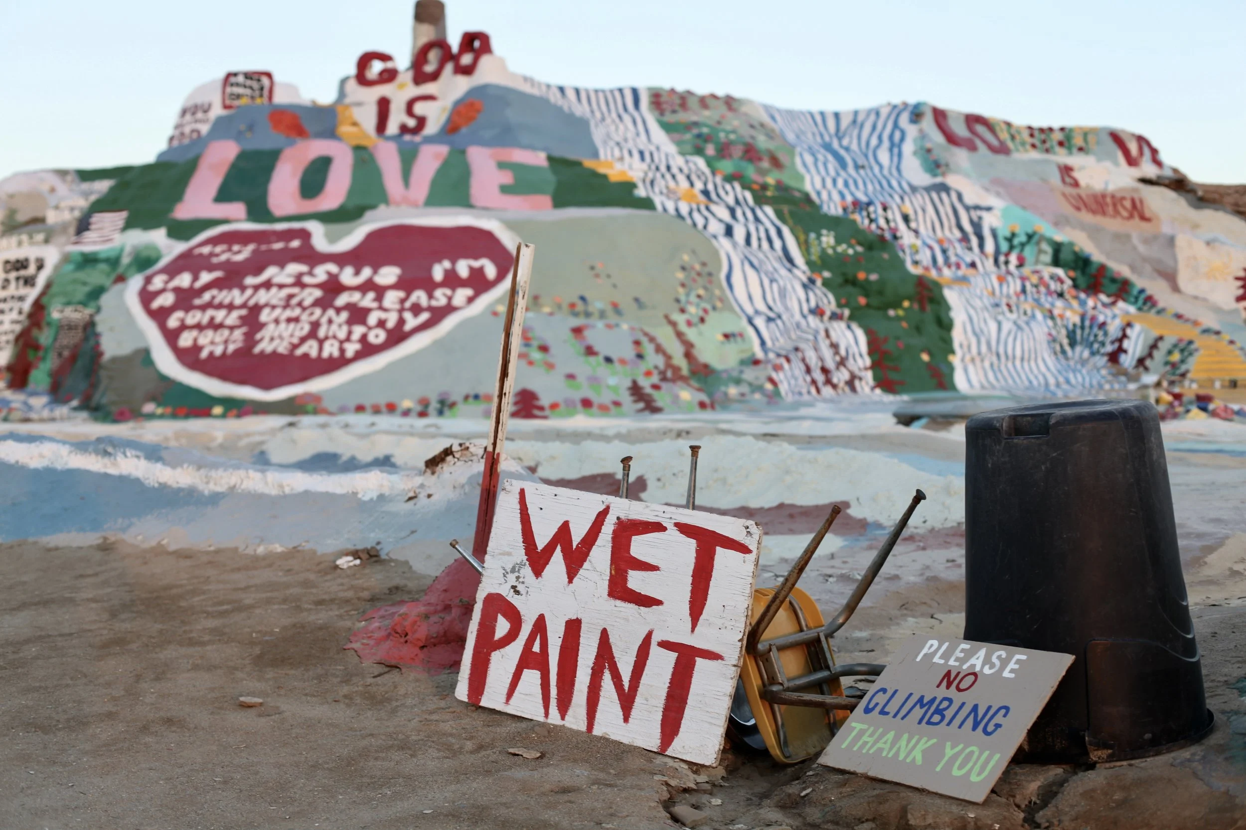 A sign warns tourists about a freshly painted section of Salvation Mountain in Slab City, Calif. on Jan. 6, 2017. (Photo by Ethan Jakob Craft.)
