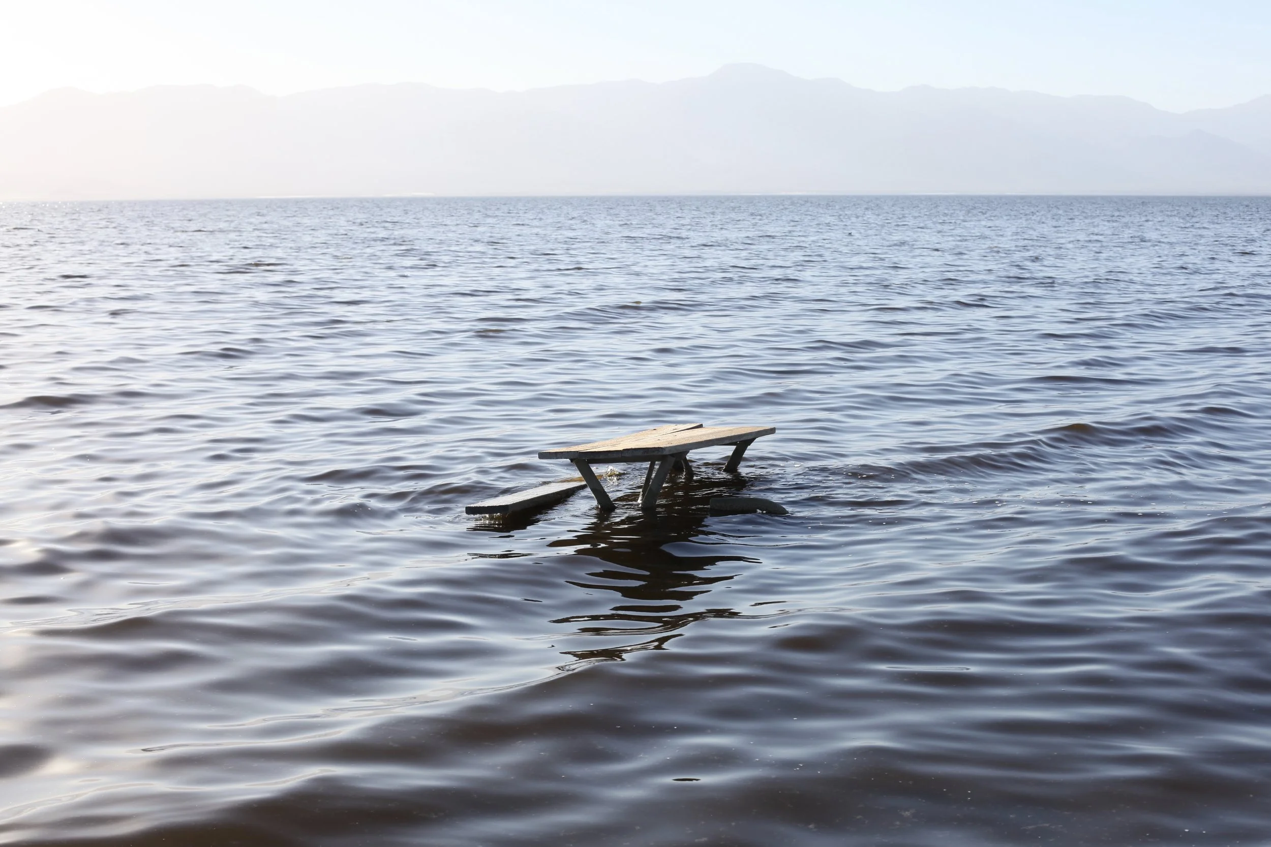 A damaged picnic table sits partially underwater during high tide at Mecca Beach on Jan. 6, 2017. (Photo by Ethan Jakob Craft.)