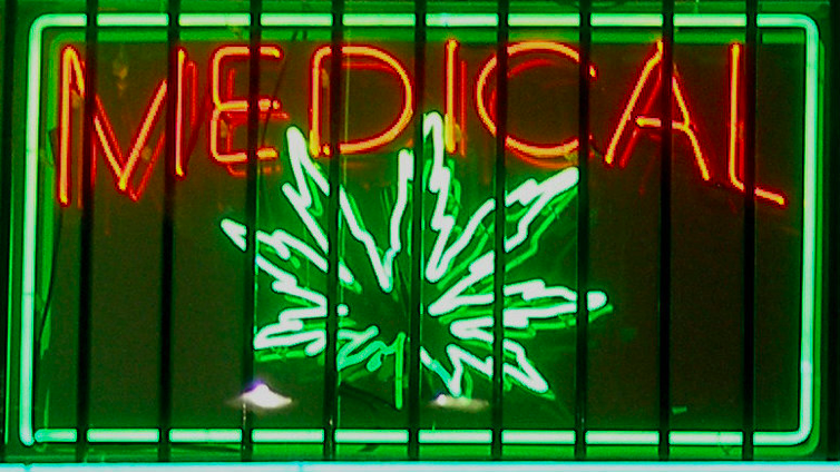 A sign in the storefront of an illegal medical marijuana clinic.