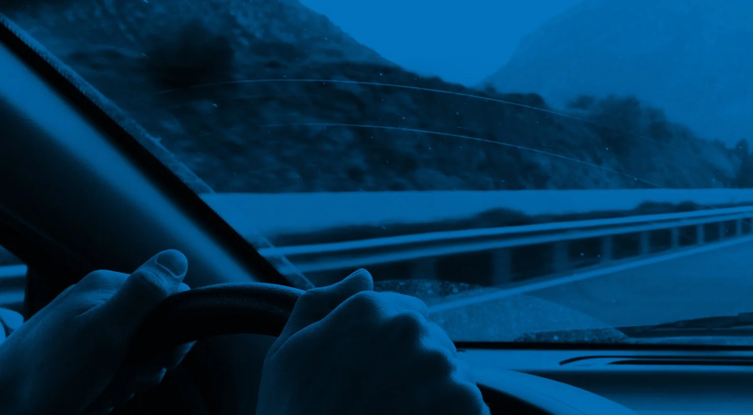Hands_of_driver_on_the_steering_wheel_Bluified_evensmaller.jpg
