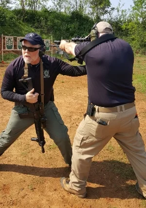 Mike demonstrates proper stance and rifle manipulation.
