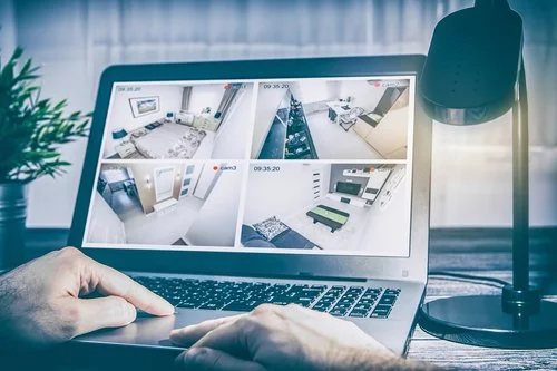 Picture of a laptop displaying home surveillance feeds