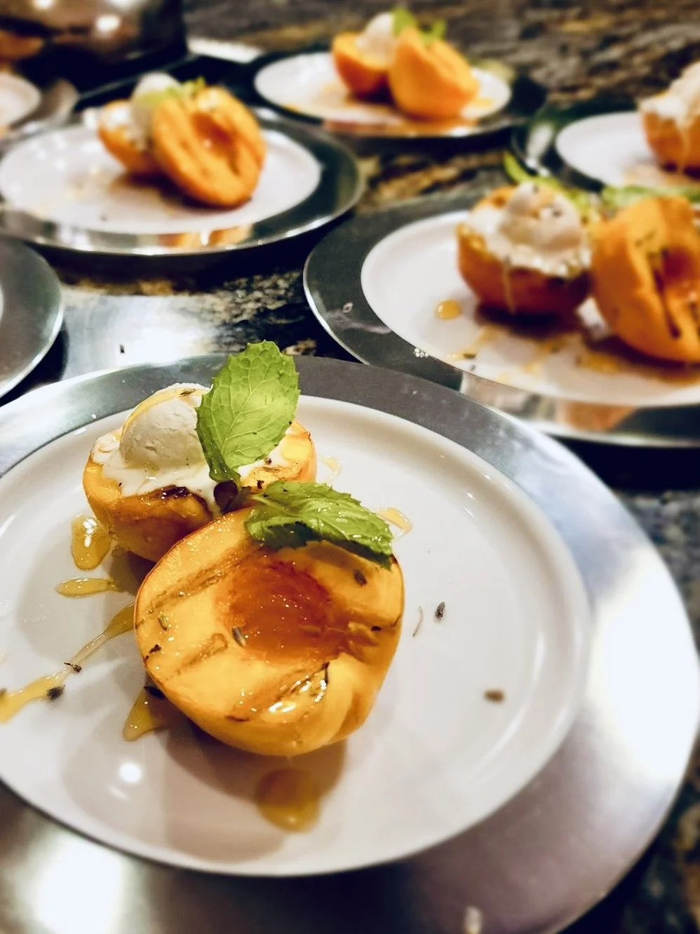 Grilled Palisade, Colorado Peaches with Vanilla Ice cream, Local Honey, lavender, and  mint.