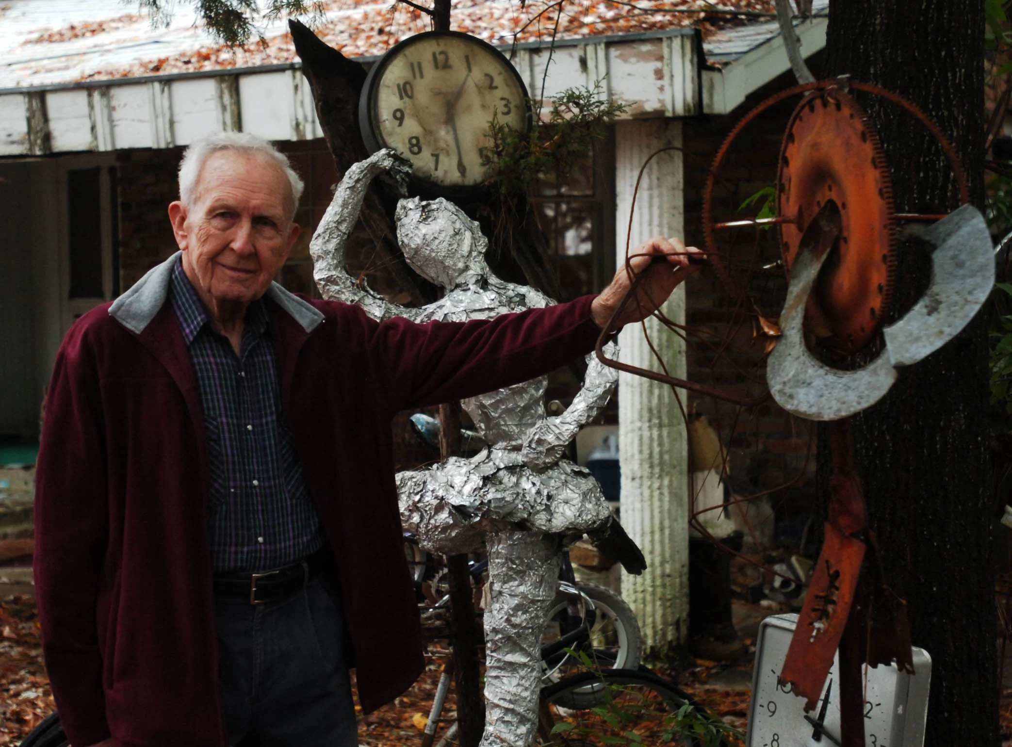 gene hatfield artist in his yard.jpg
