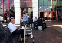  Older Vietnamese men gather outside the Asian Garden Mall to play cards and drink coffee. Photograph by author. 