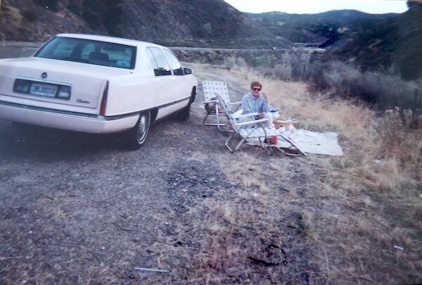  Ude's wife, Shirley, was a long-time Mary Kay Cosmetics representative. Here she is at a roadside picnic with Ude, by one of her many MK pink Cadillacs!  