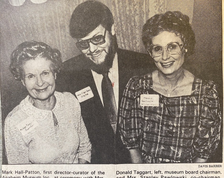  Mark Hall-Patton flanked by his bosses, Midge Taggart (l) and Theresa Pawlowski of Anaheim Museum Inc.  Los Angeles Times , March 14, 1984. 
