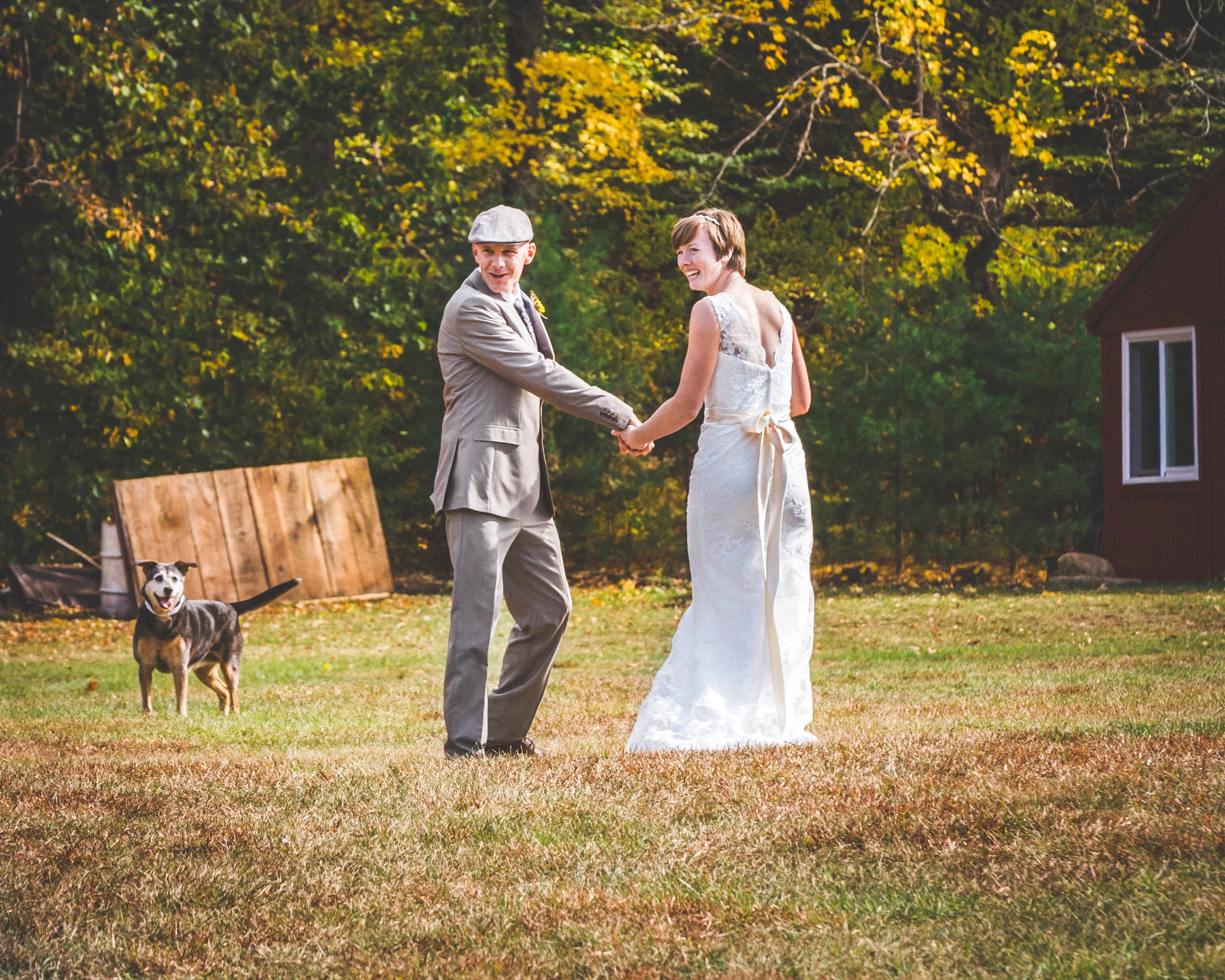 This adorable couple is Elisa and Scott. Elissa has a lace fit and flare with a light ribbon. Scott has a gray suit which he chose to accessorize with a pageboy hat. This couple chose to have their dog as part of their big day.