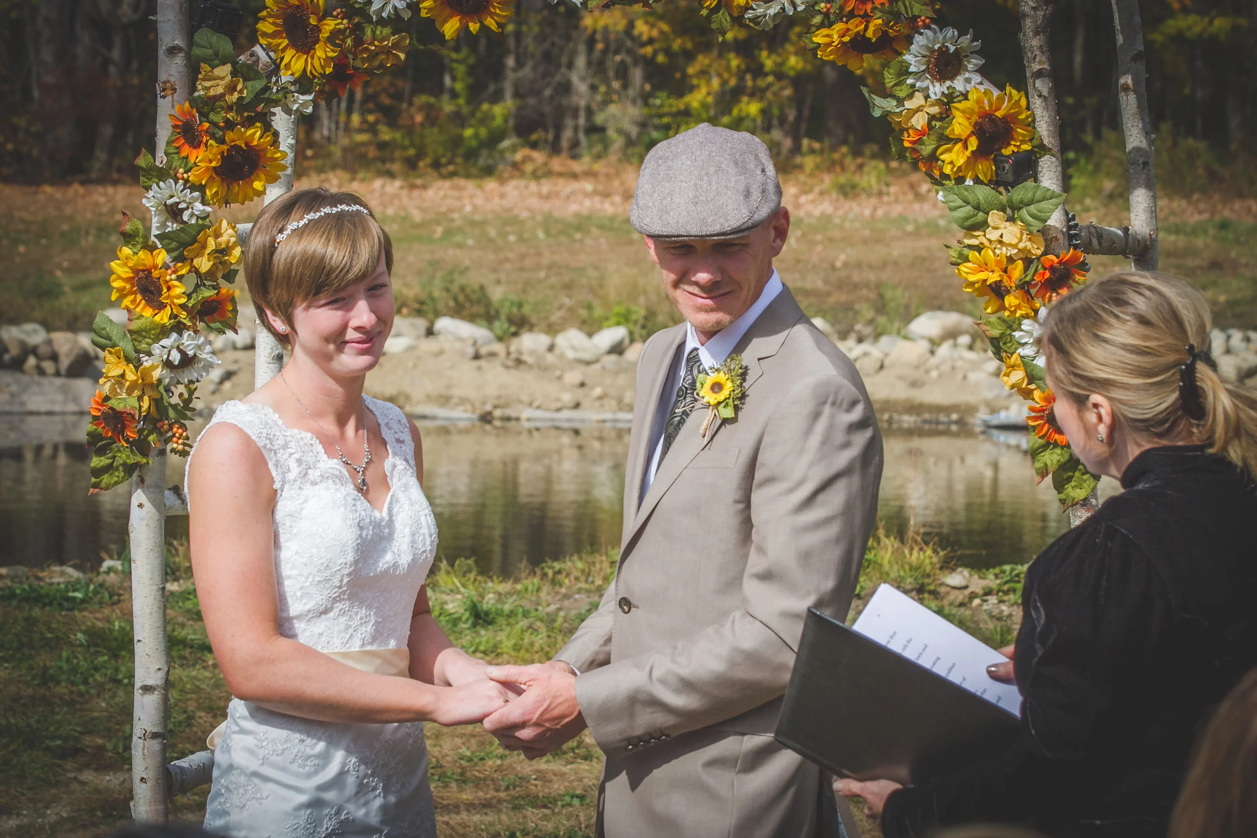 Elissa and Scott chose to get married before the pond. They have a sunflower adorned birch archway as well.