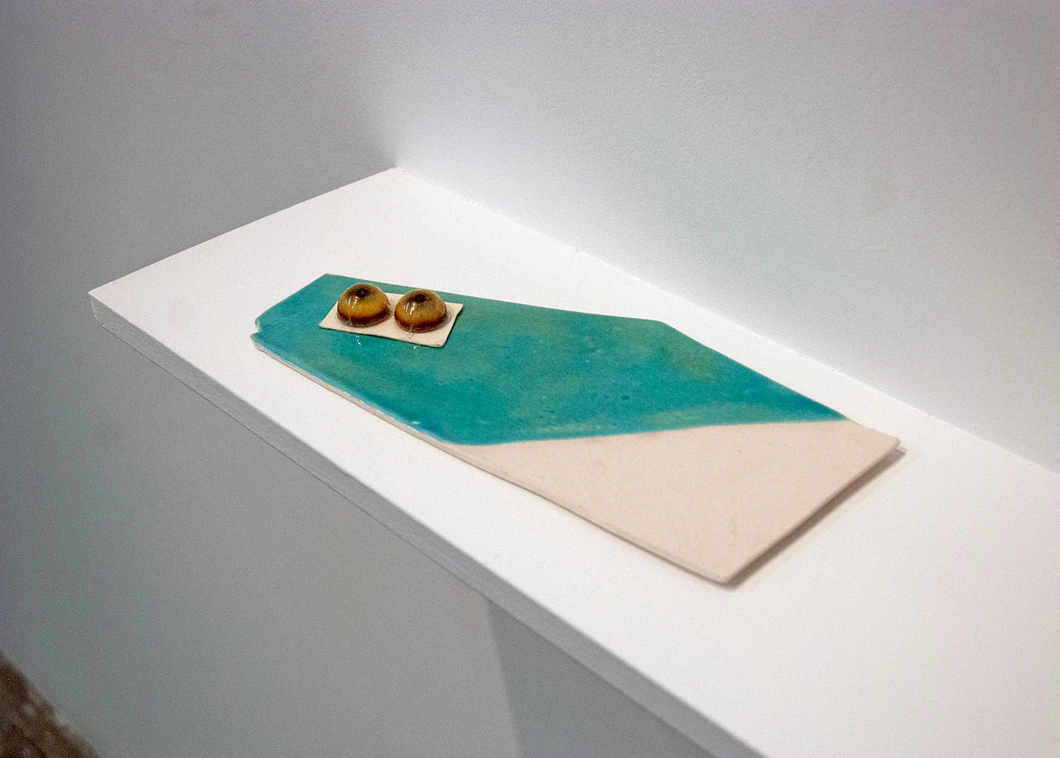   A place where you buy things for sculpture that has glass eyes,  2014, glazed porcelain and glass eyes, .75 x 11 x 5.25 inches 