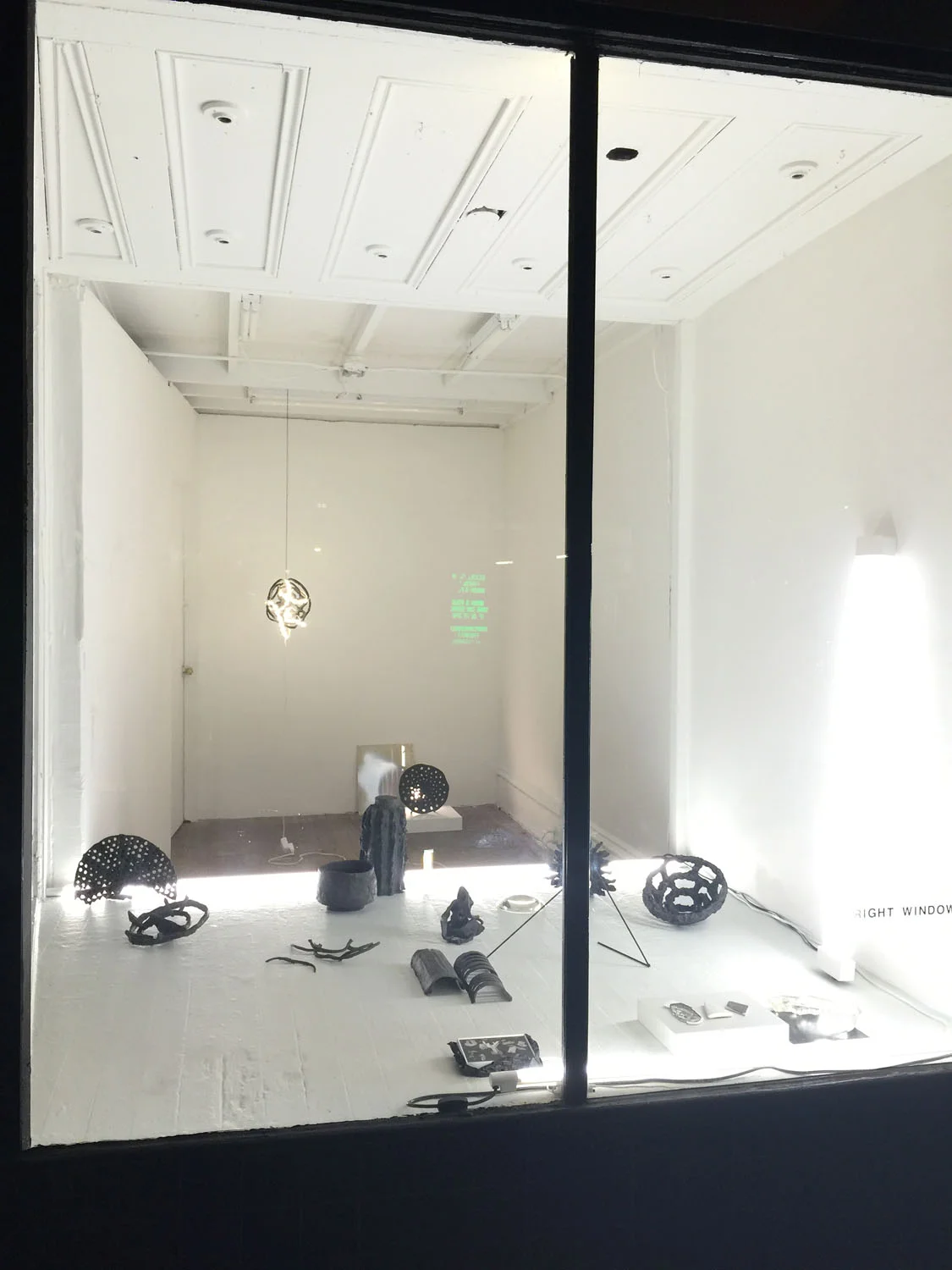 Vases and Hallucinations , installation view, 2015, glazed and unglazed ceramic, porcelain, LED lights, black yarn, crystal ball, glass prism, flashe on digital chromogenic print, cinefoil, painted steel, latex and metallic spray paint on acrylic, cast glass, laser print on plaster, wood stick with primer and metallic spray paint, 30 second movie loop on iPhone, size variable