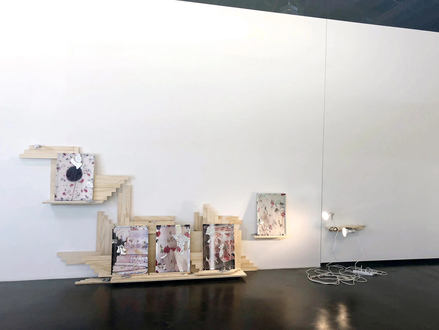 Darling Dark Direct Directly, installation view, 2018, in Seven Places of the Mind exhibition (curated by Margaret Tedesco), acrylic on cork board, poured aluminum, pearl head straight pins, wood, plywood, dowels, porcelain clamp lamps, LED flood lights, power strip, extension cord, size variable