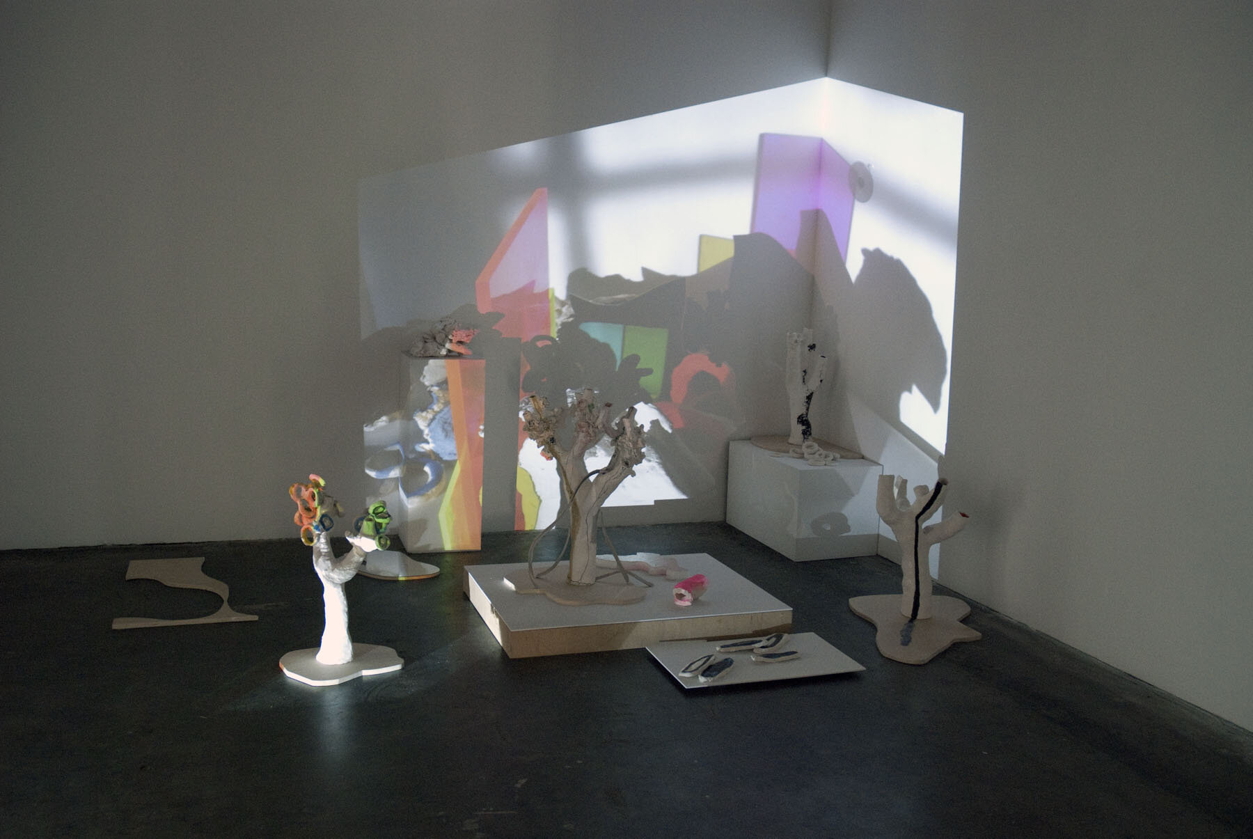   Everything is Everything , installation view, 2010, 30-minute projected digital movie loop, glazed and unglazed ceramic, spray paint, acrylic, archival pigment print on paper, plywood, mirrored plexiglas, latex, 122 x 241 x 192 inches 