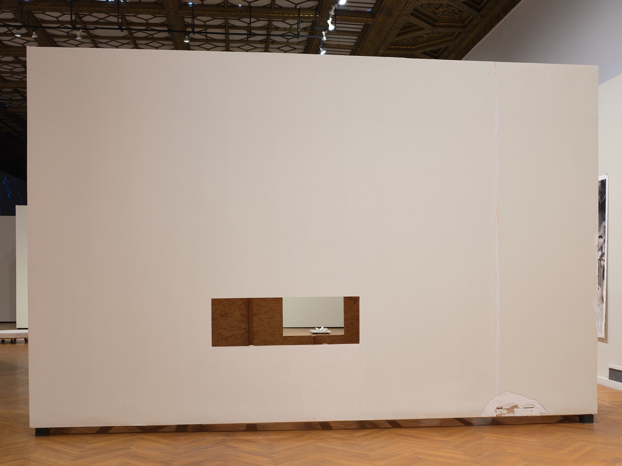   Into The Matter , installation view, 2018, altered moveable museum wall, sheetrock joint compound, latex paint, lumber, OSB sheathing,  127 x 168 x 36 inches.   
