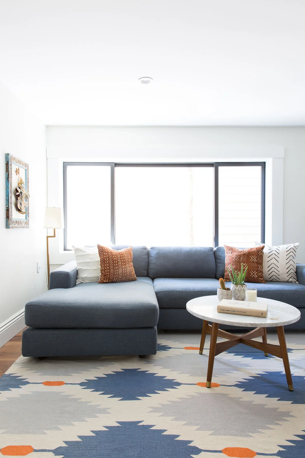 Love-&-Interiors-San-Francisco-Pacific-Heights-Cozy-Blue-and-Orange-Family-Room-with Sectional-and-Leather-Dhurrie-Rug-MCM-Coffee-Table.jpg