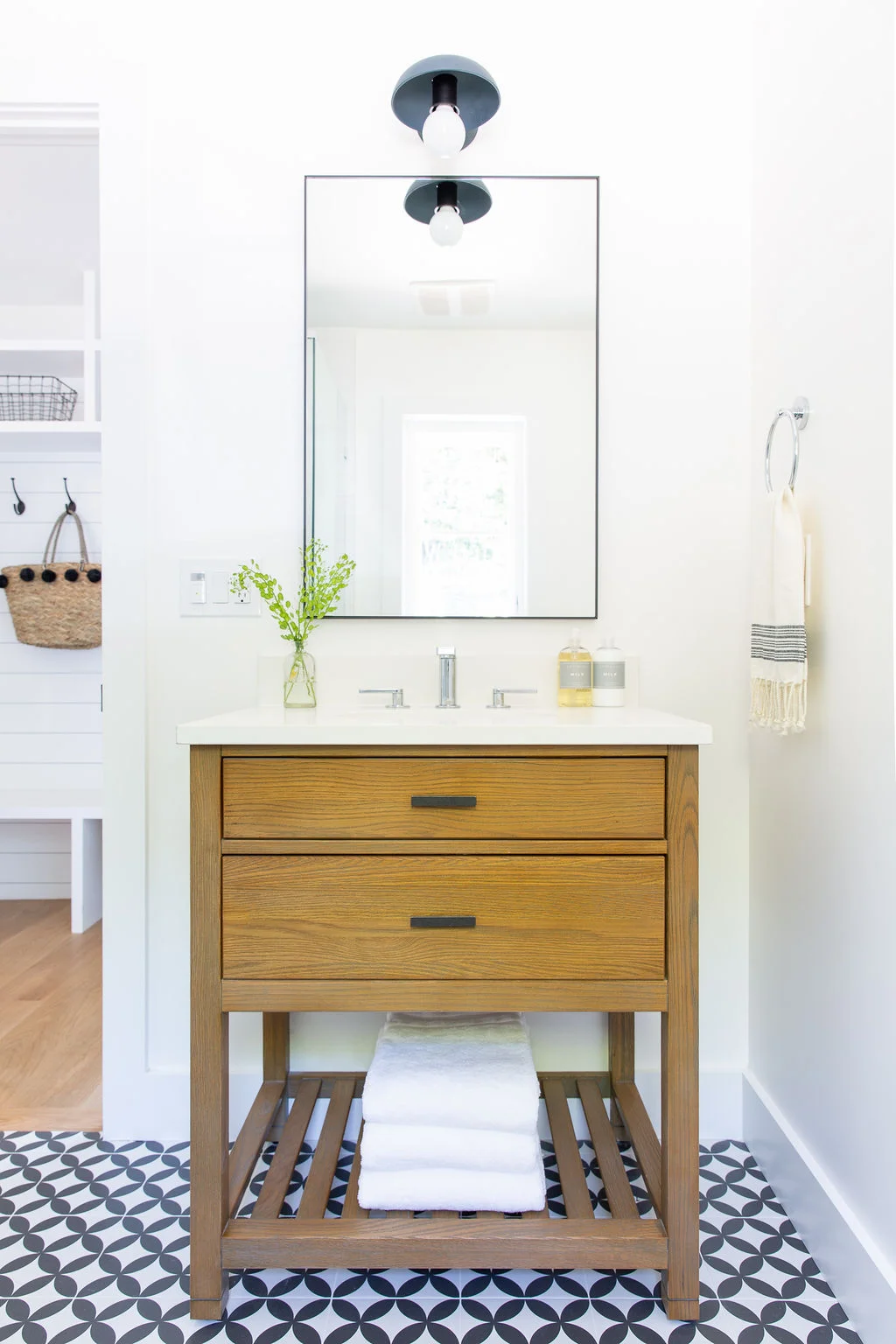 Love-&-Interiors-Mill-Valley-Modern-Farmhouse-Guest-Bath-Black-Mirror-Blue-Sconce-Wood-Vanity-Open-Shelf-Patterned-Floor-Black-Hardware.jpg