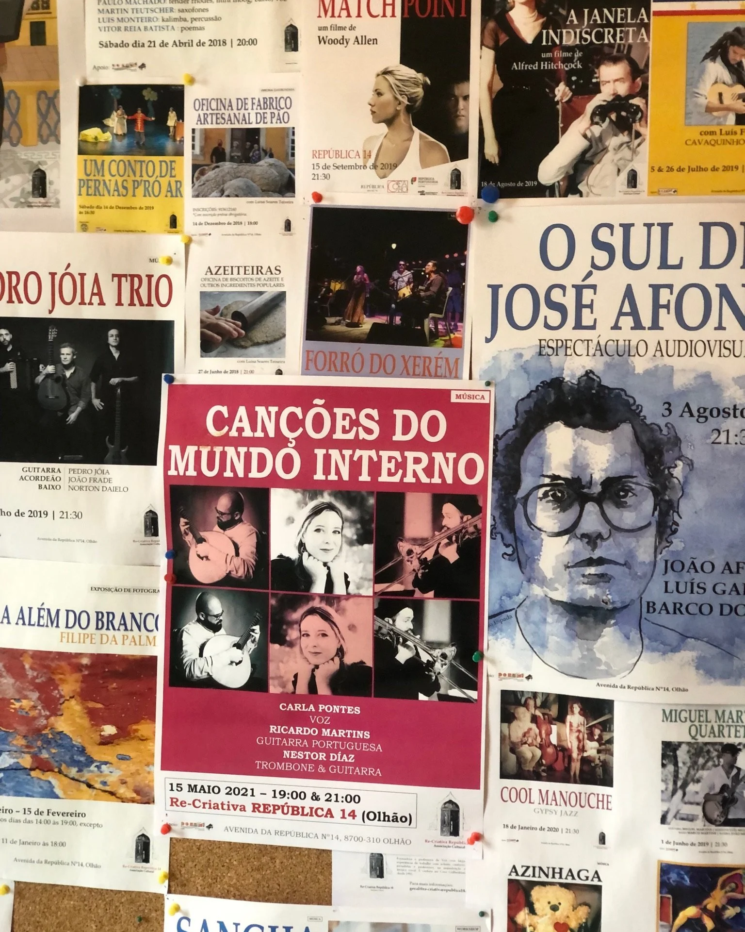 The events noticeboard at ReCreativa in Olhão, a cultural space a short walk from Casa Fuzetta, layered with posters for local concerts, films and workshops at República 14.