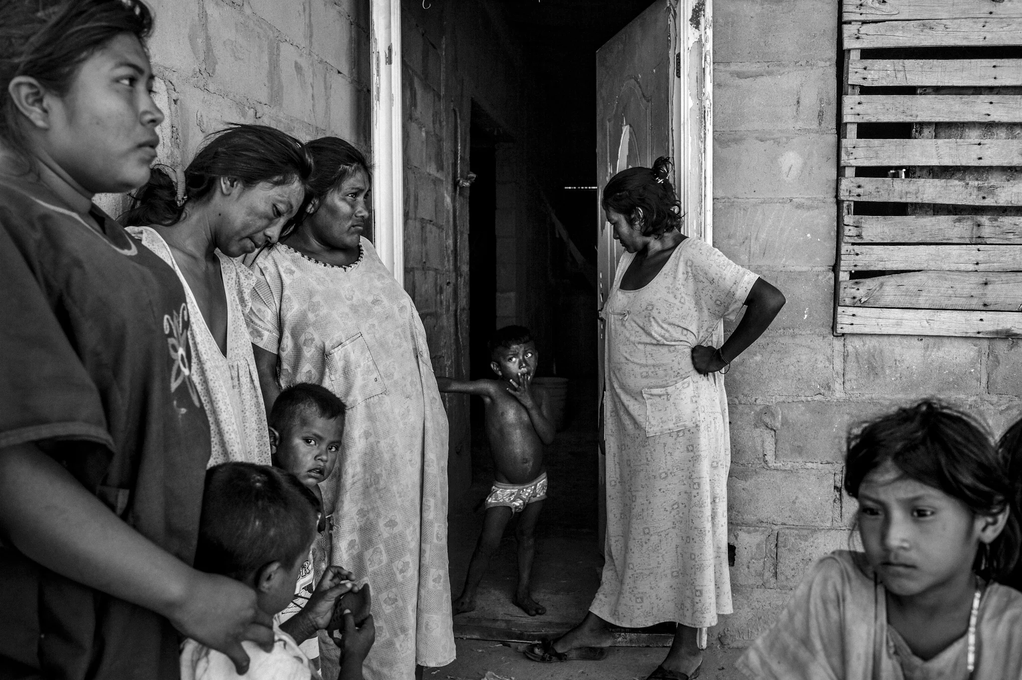  Olga, 27, center, looks at one of her children with obvious signs of denutrition.&nbsp; Last month, she lost two of her five children because of malnutrition.    