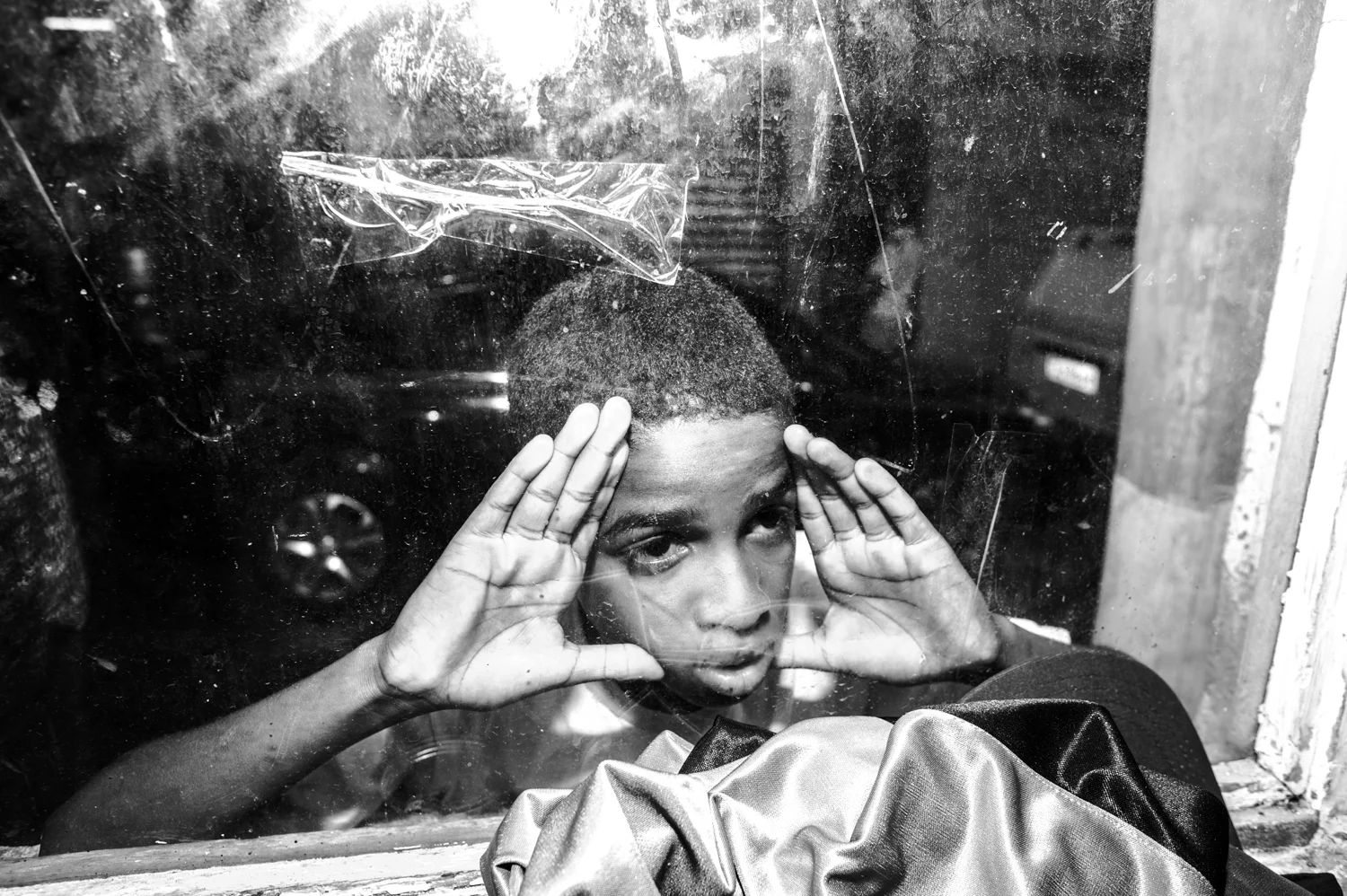  Young boy peering fascinated a passinho training in Jacarezinho, Rio de Janeiro. 