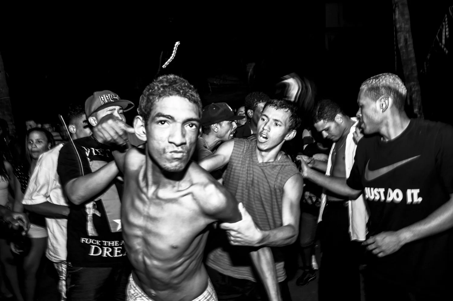  A "cracudo" (crack addicted) breaks into the scene during a Saturday night's baile funky  in favela do Jacarezinho. Jacarezinho means little crocodile in brazilian. 