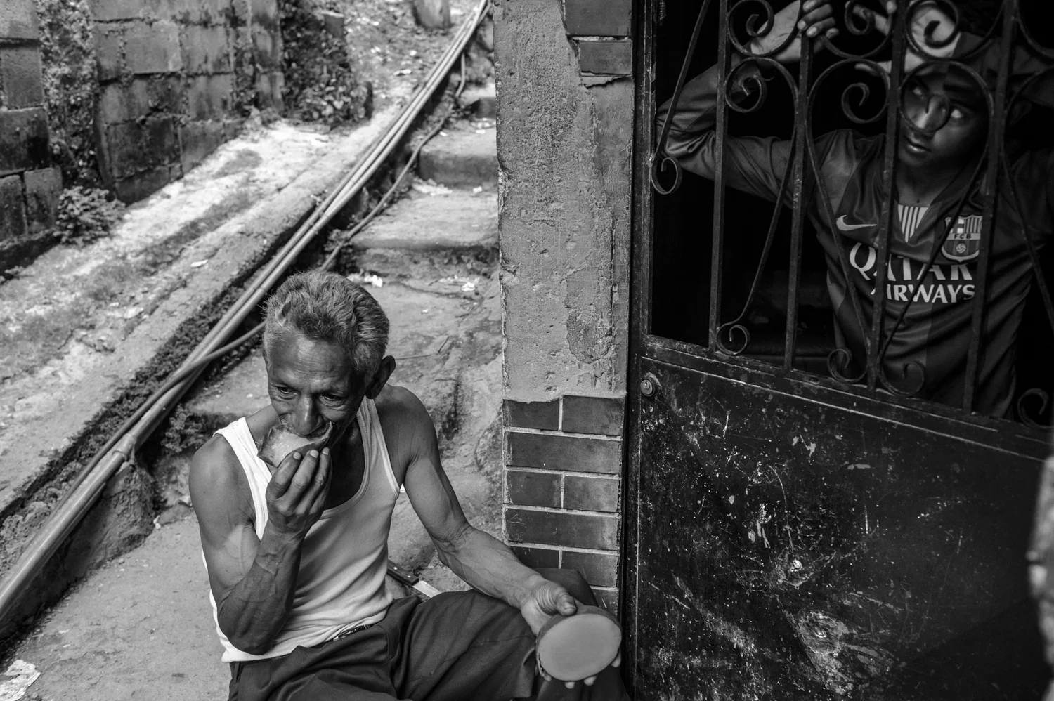  A man eats a mango for lunch in front of his shack in Petare, the largest slum in Caracas. Venezuela is facing a severe economic crisis and a large part of population has no access to essential food products at a reasonable price due to one of the h