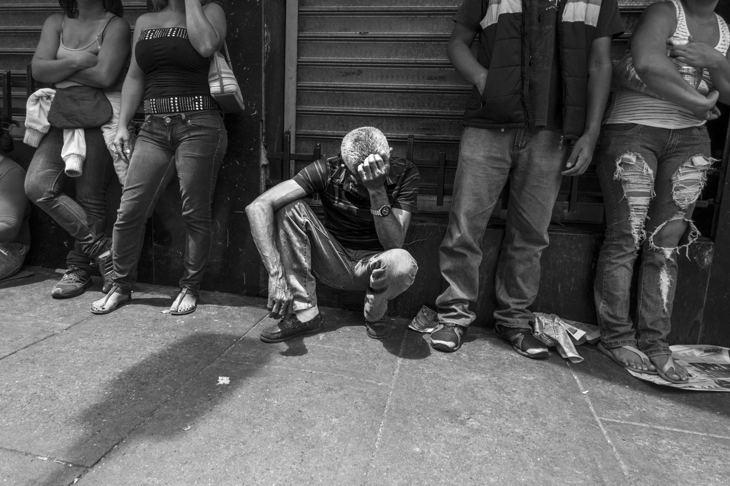  A man waits in line to buy some bread in the Chacao district.&nbsp; 